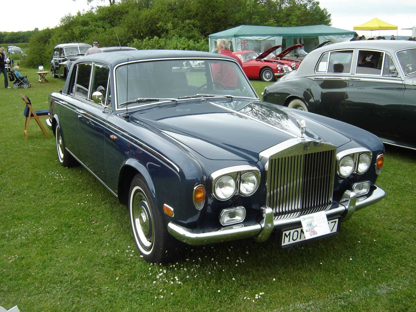 A dark blue Rolls-Royce Silver Shadow on a show field, front three-quarter view