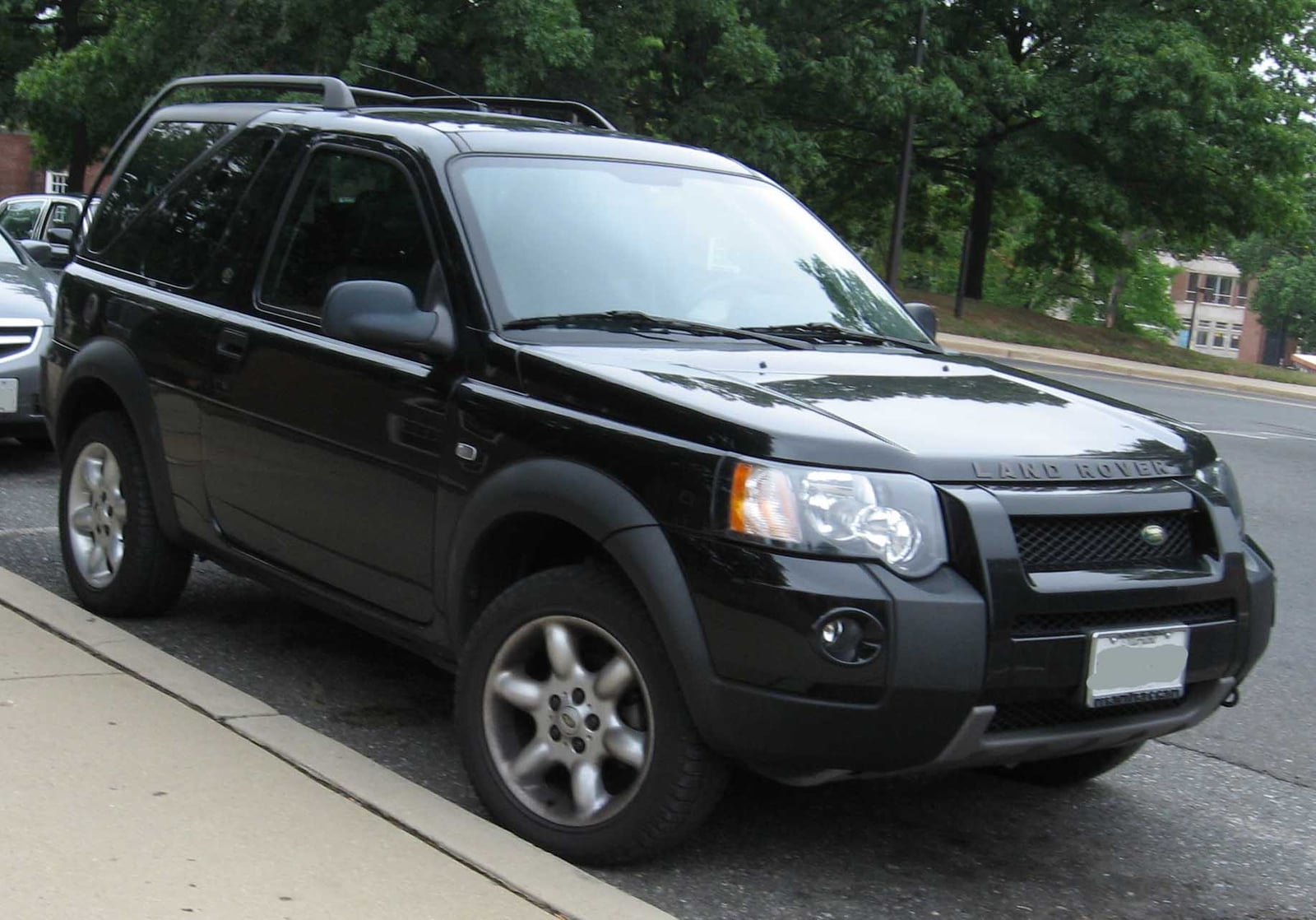 A black facelift Land Rover Freelander three-door Softback with its roof in place, parked on a street