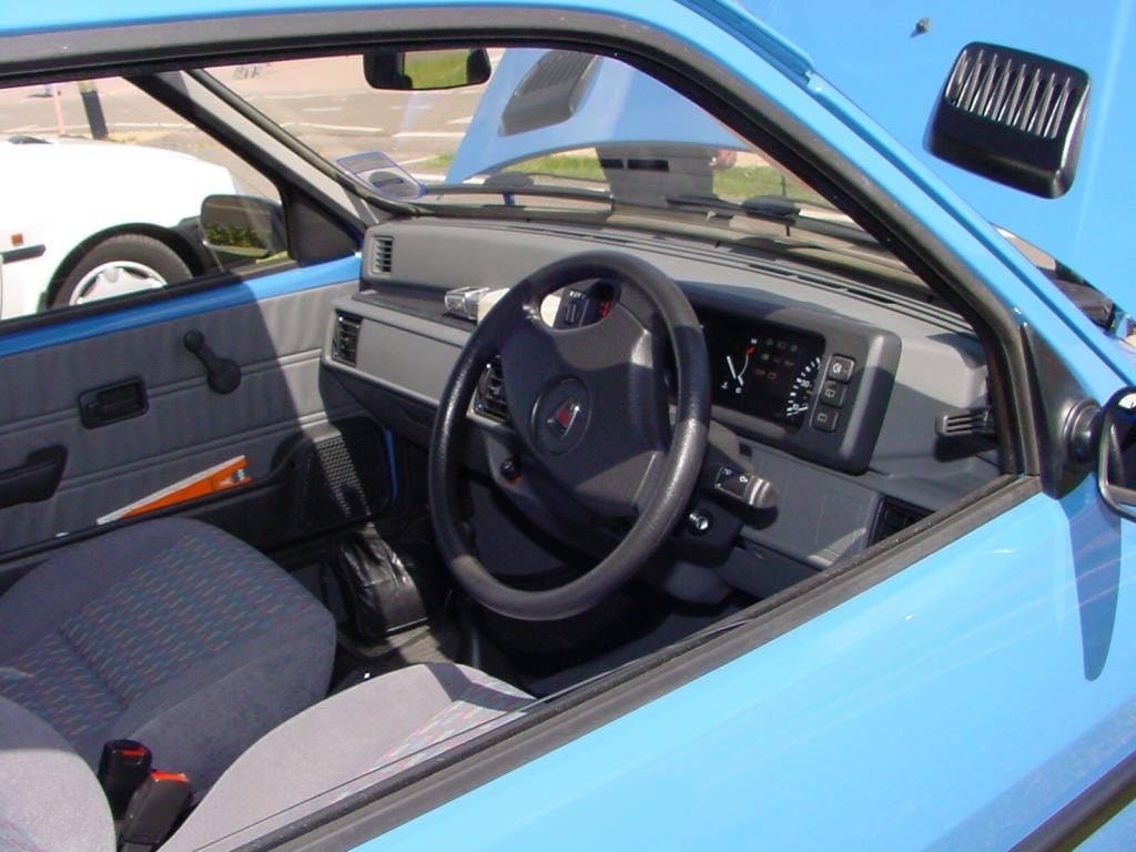 The interior of a 1993 Rover Metro Quest showing the dashboard, steering wheel and cloth seats