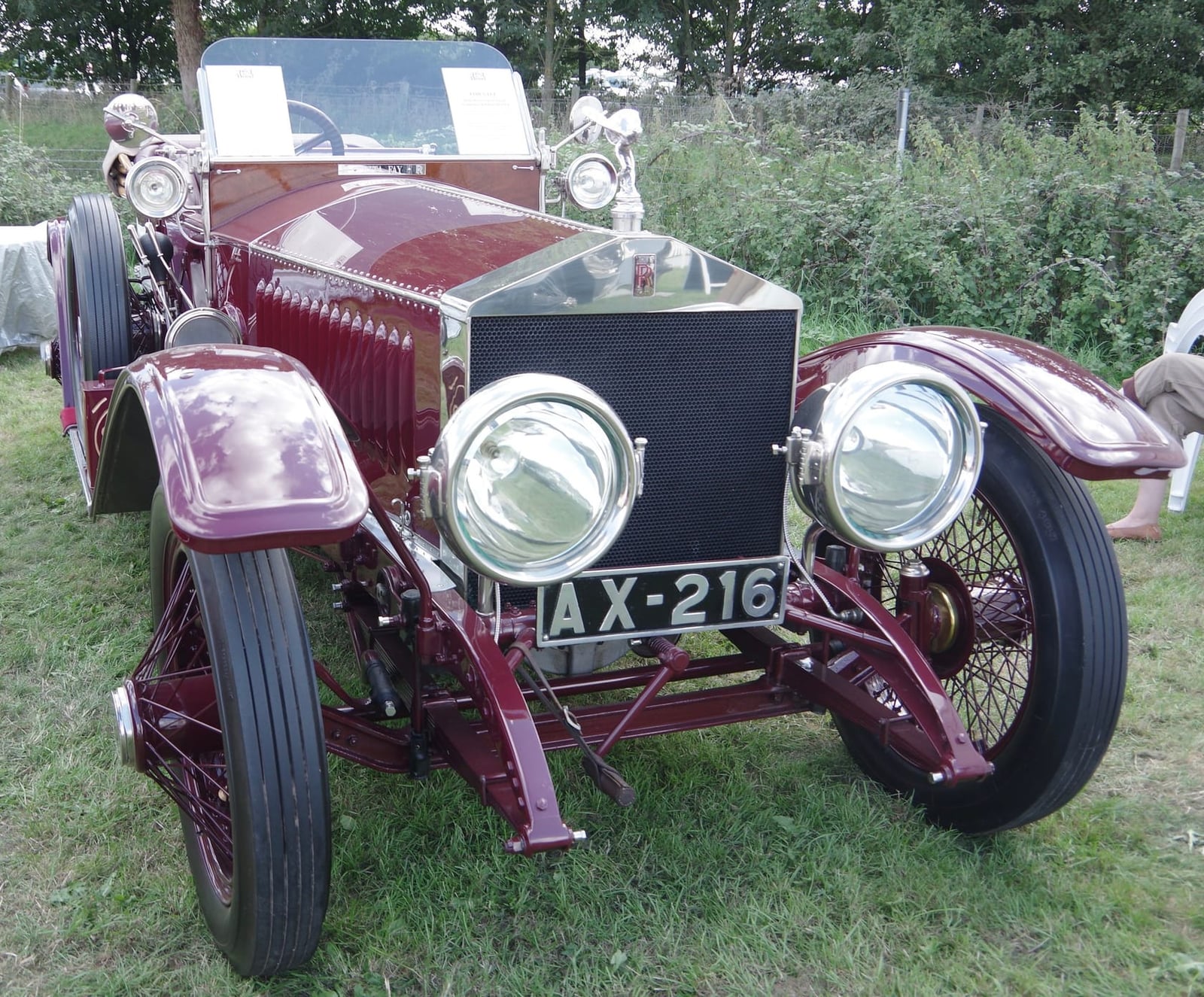 A maroon 1914 Rolls-Royce Silver Ghost London-to-Edinburgh model with large brass headlamps