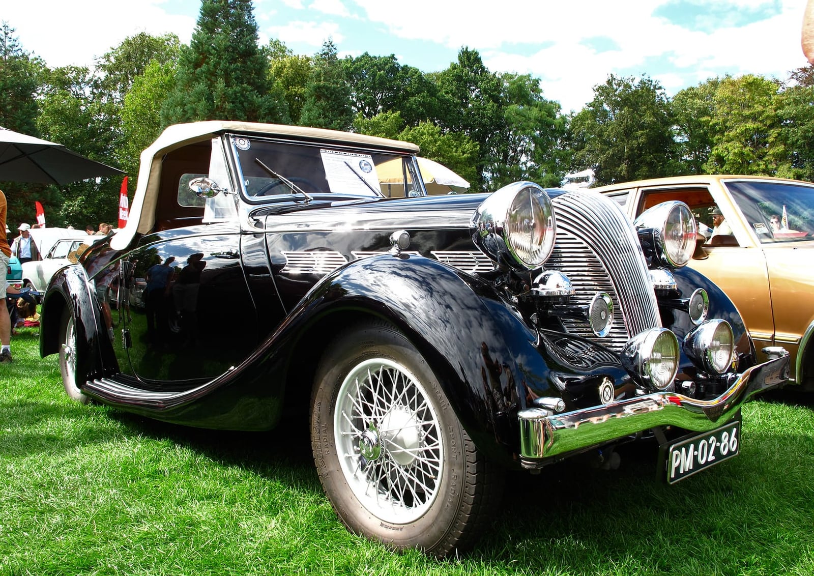 A dark pre-war 1939 Triumph Dolomite 14/65 Roadster Coupe at a classic car show, front three-quarter view