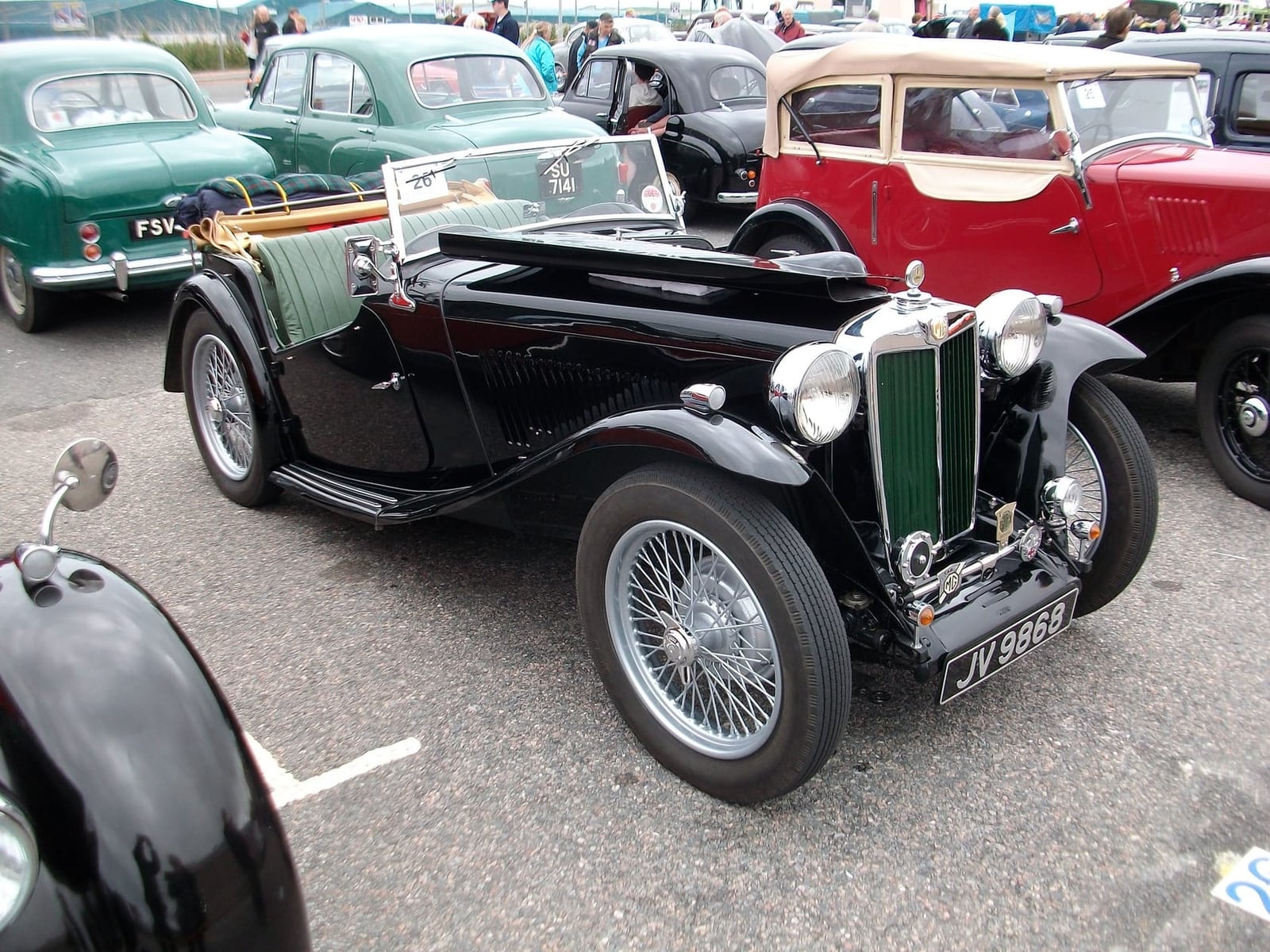 A black MG TC of 1946 on grass, front three-quarter view