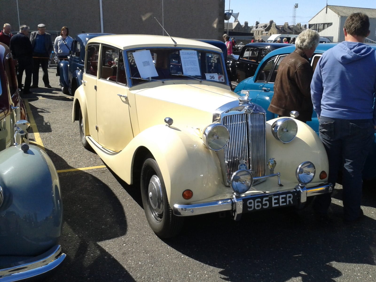 A cream 1952 Triumph Renown at an indoor classic car show with visitors around it, UK registration 965 EER