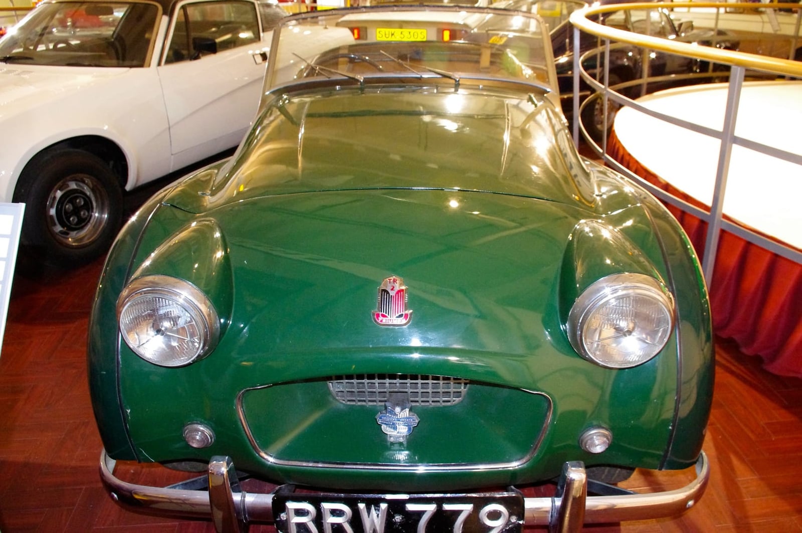 A green Triumph TR2, front three-quarter view in a motor museum