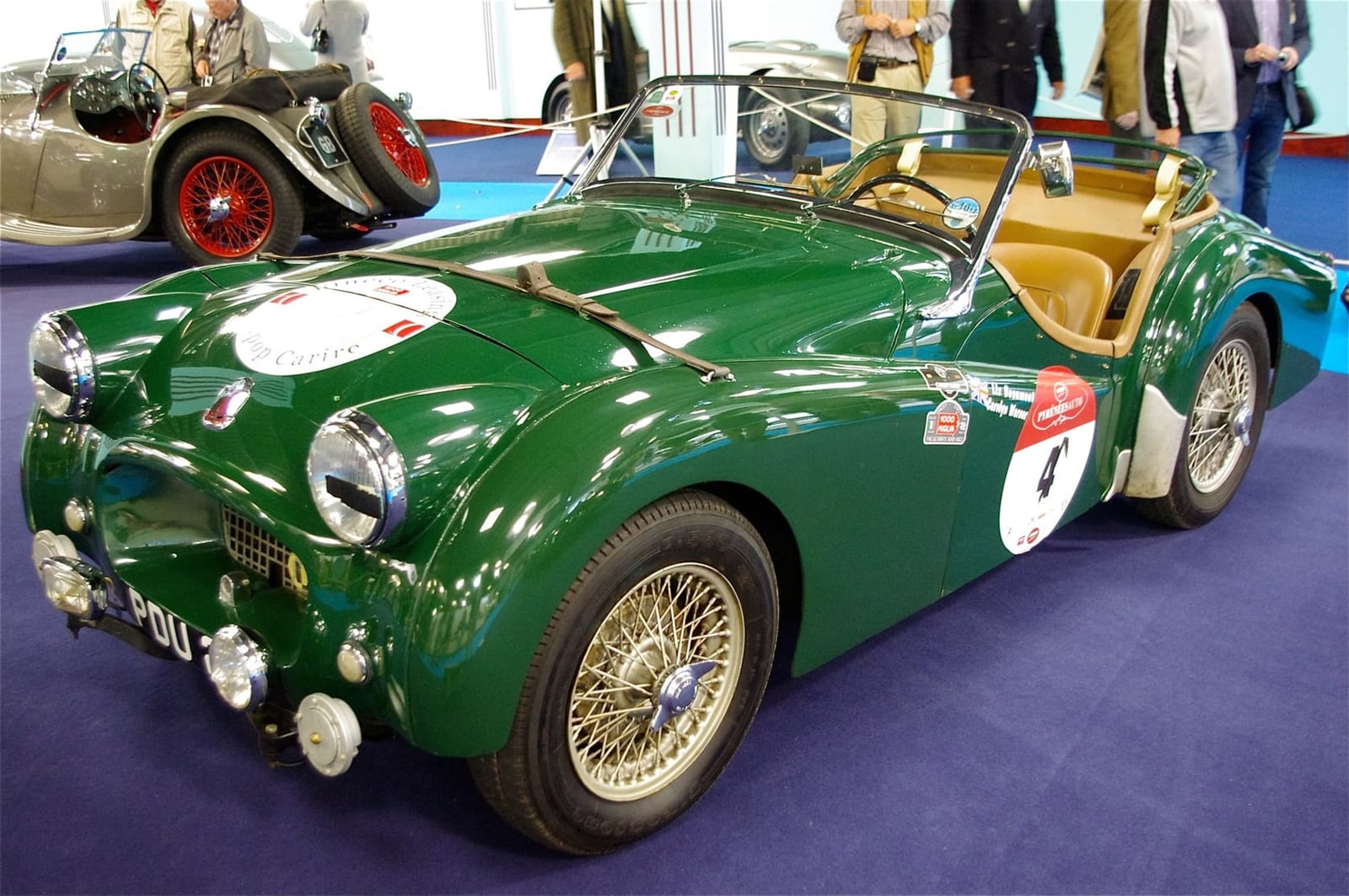 A green Triumph TR2 competition car on display