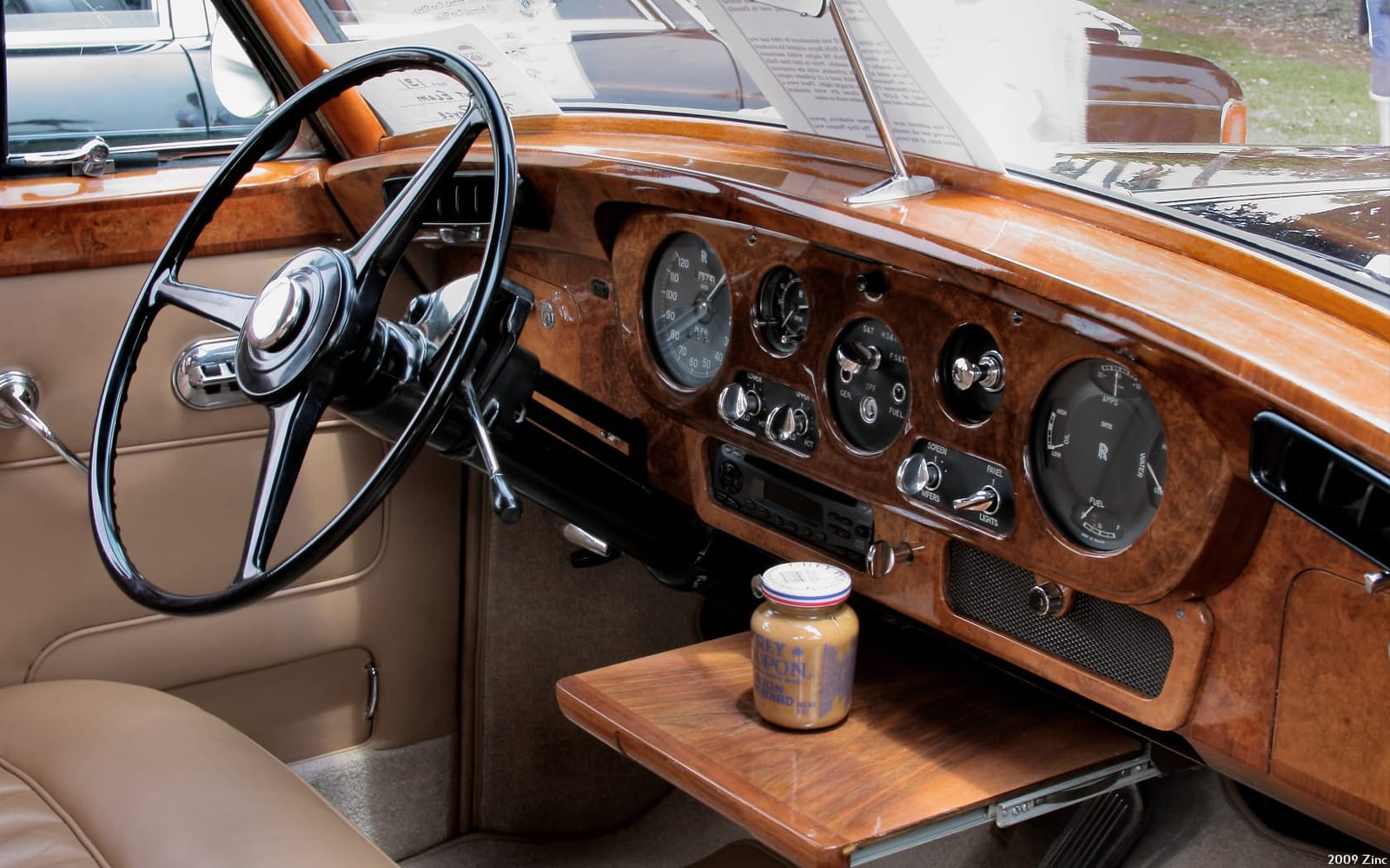 The burr walnut dashboard and picnic table of a 1962 Rolls-Royce Silver Cloud II