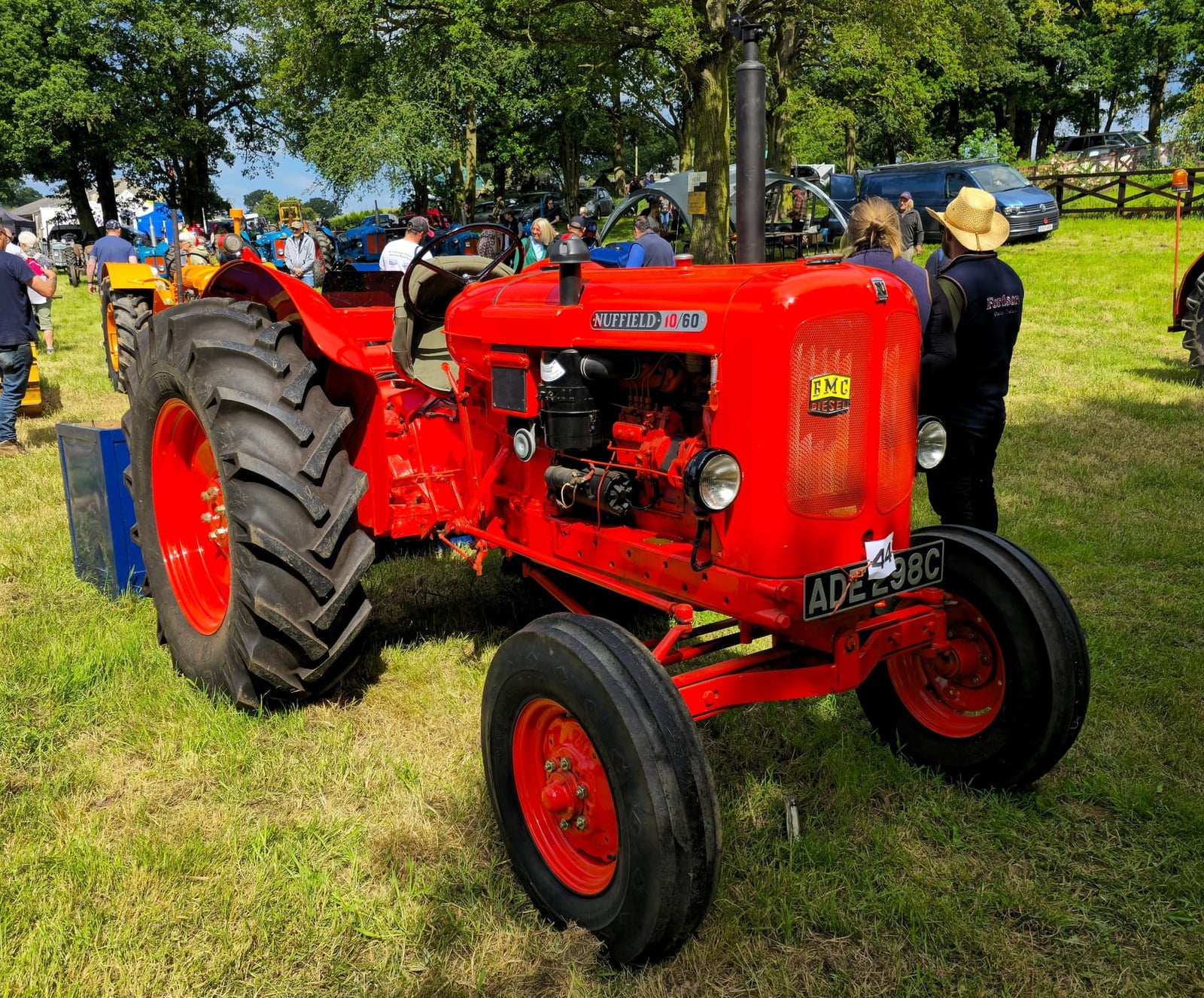 An orange Nuffield 10/60 at a vintage rally