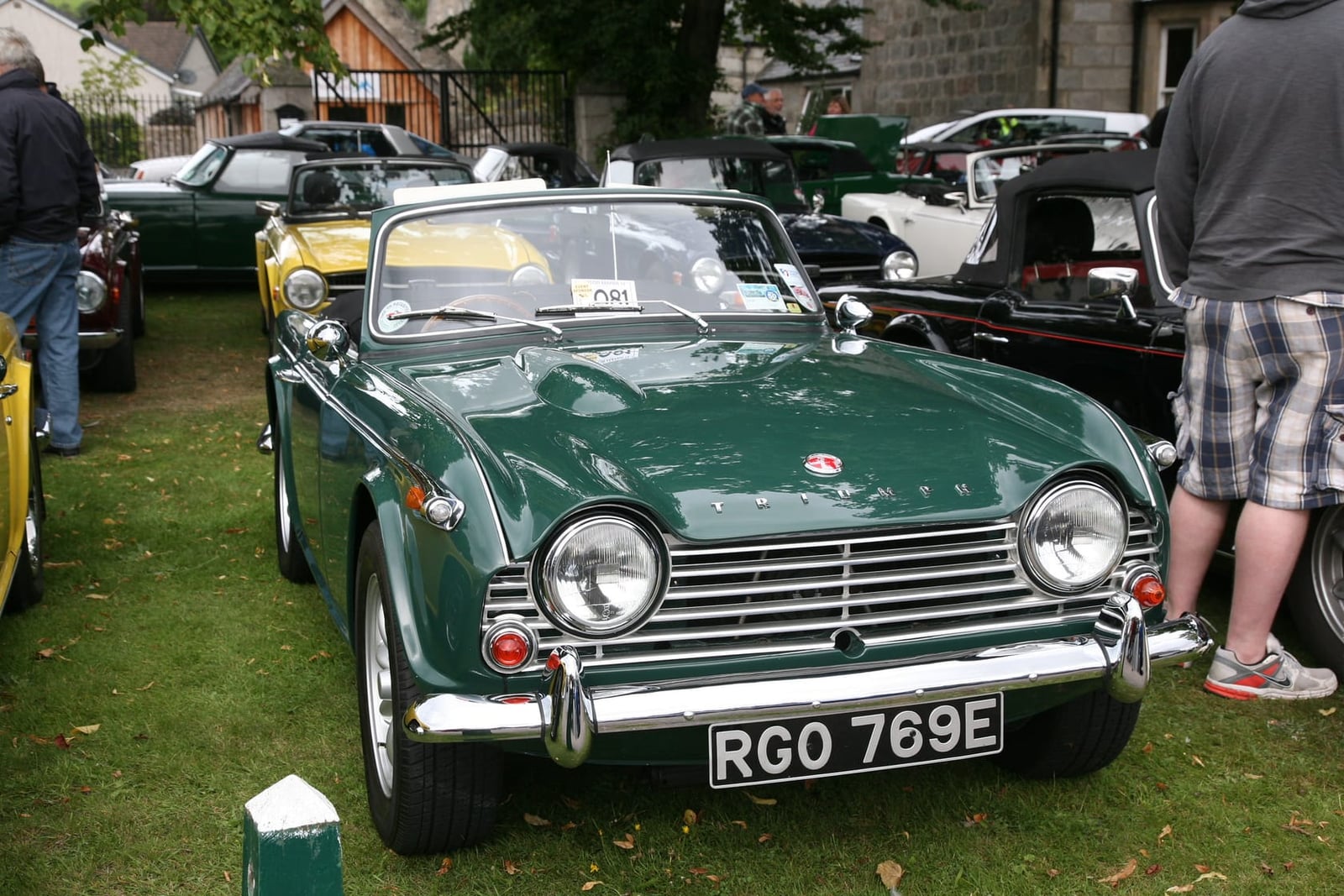 A green Triumph TR4, front three-quarter view at a show