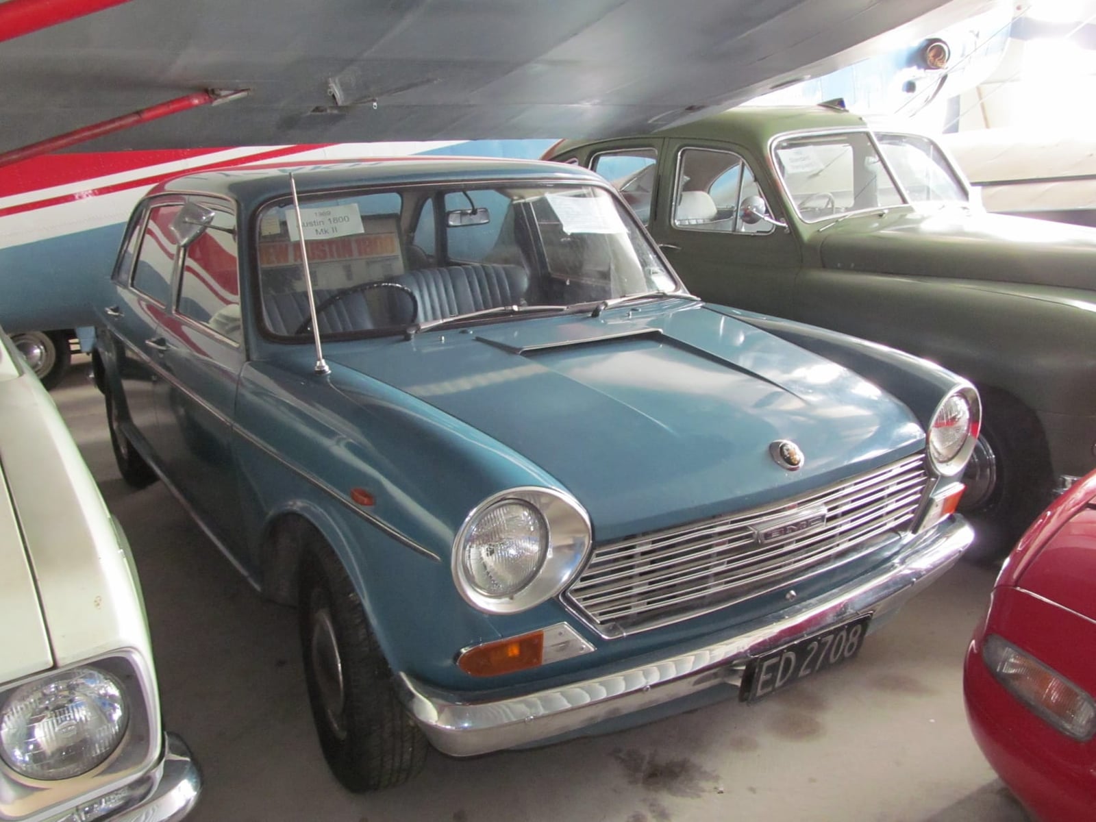 A blue 1969 Austin 1800 Mk II on indoor display at a classic car show, front three-quarter view, UK registration ED 2708
