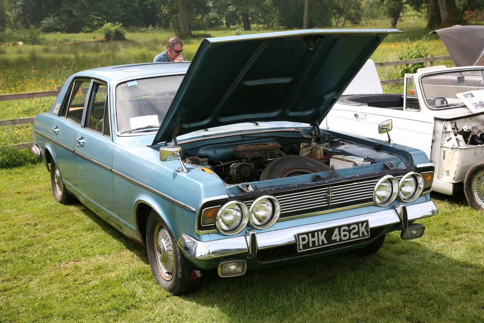 A pale blue Ford Zodiac Mk4 Executive with the bonnet raised, showing the V6 engine