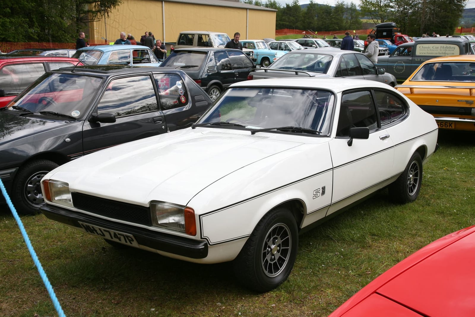 A beige Ford Capri 3.0S, front three-quarter view at a show