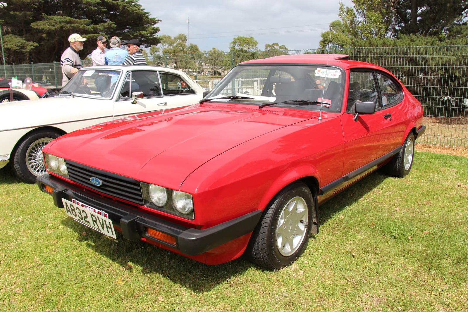 A red four-cylinder Ford Capri Mk3, front three-quarter view