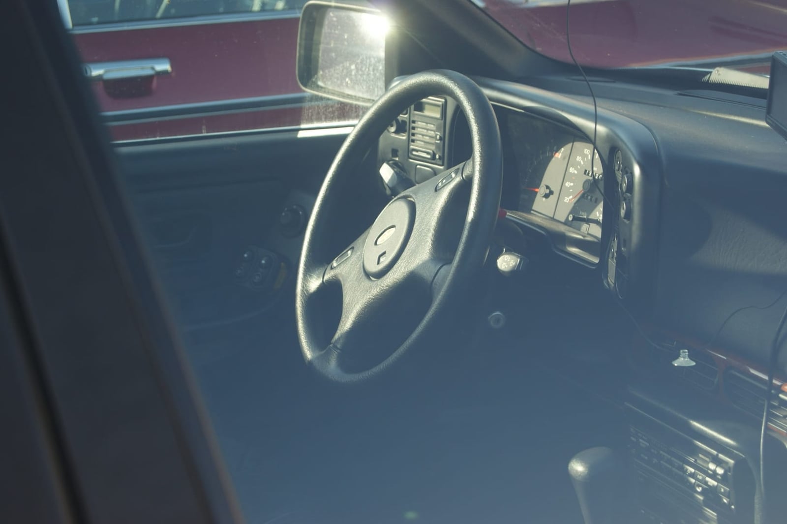 The interior of a Ford Granada Mk3, showing the steering wheel, instrument cluster and dashboard through the driver's window
