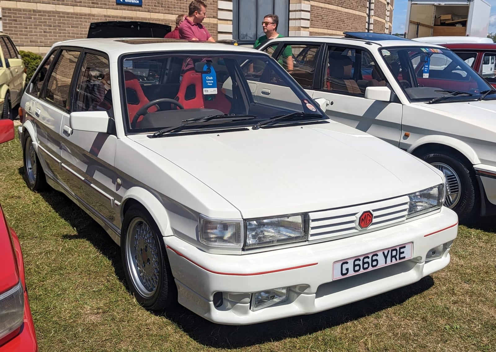 A white 1989 MG Maestro Turbo with a UK registration on grass at a show