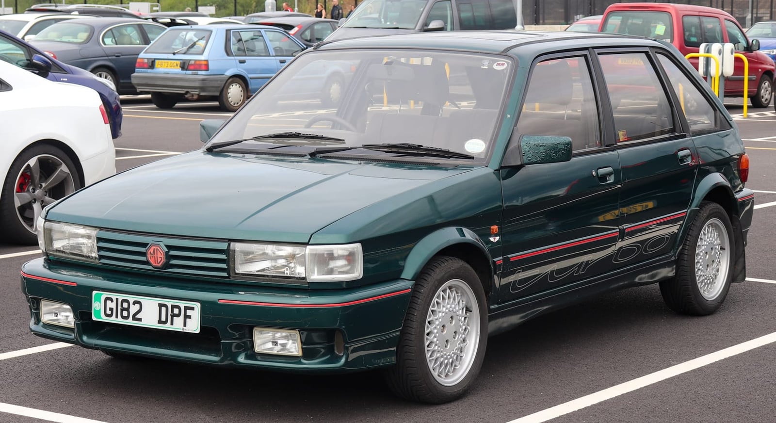 A dark green 1990 MG Maestro Turbo 2.0 with a UK registration in a car park