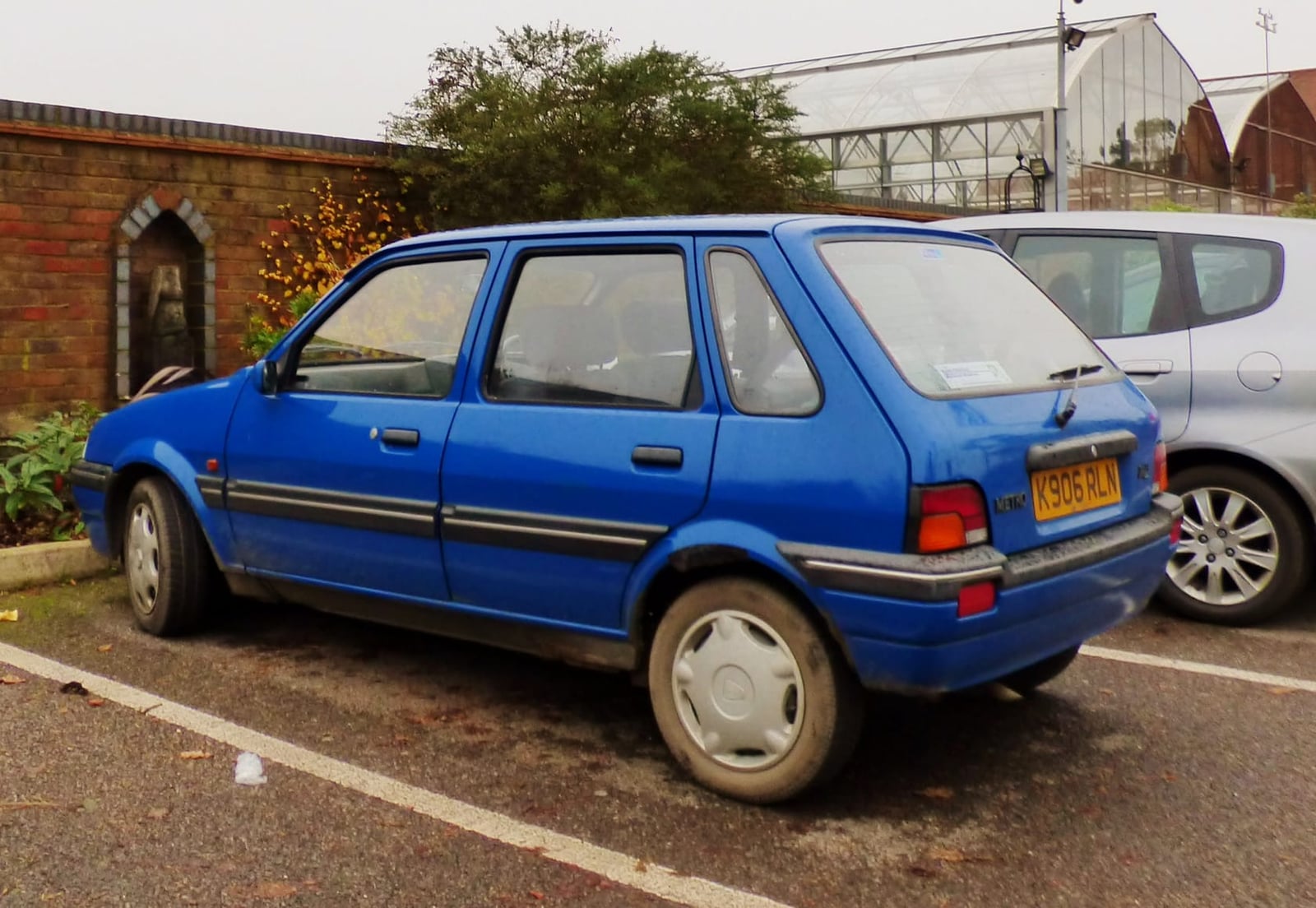 A blue 1993 Rover Metro 1.4 five-door parked on a street, side view