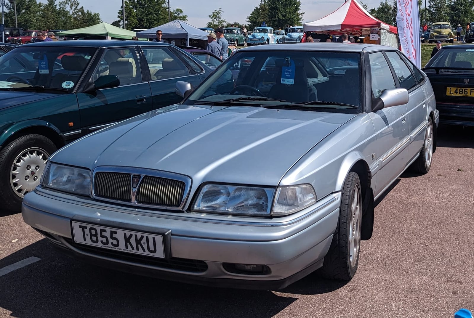 A silver 1999 Rover 820 Vitesse saloon with a UK registration on a show field