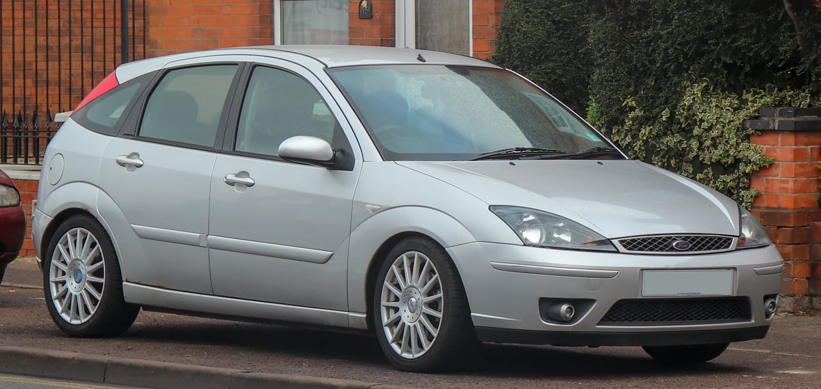 A silver 2004 Ford Focus ST170 three-door parked in a residential street