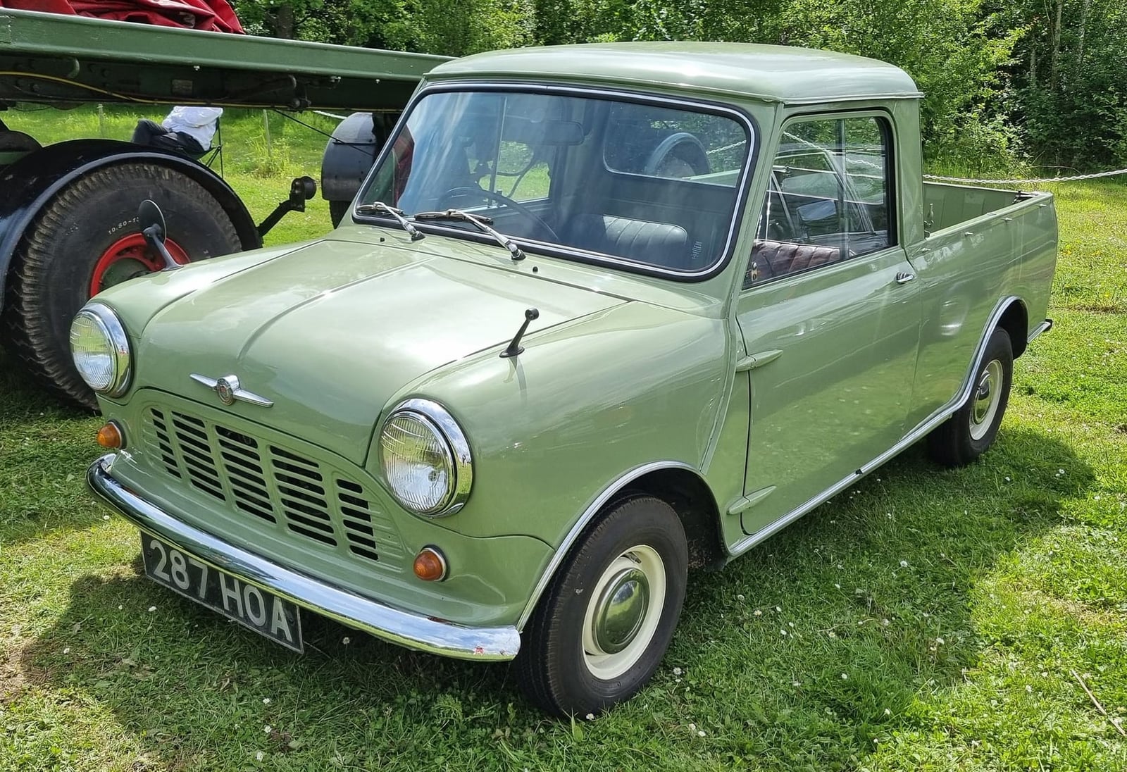 A green Mini Pick-up at a show, front three-quarter view