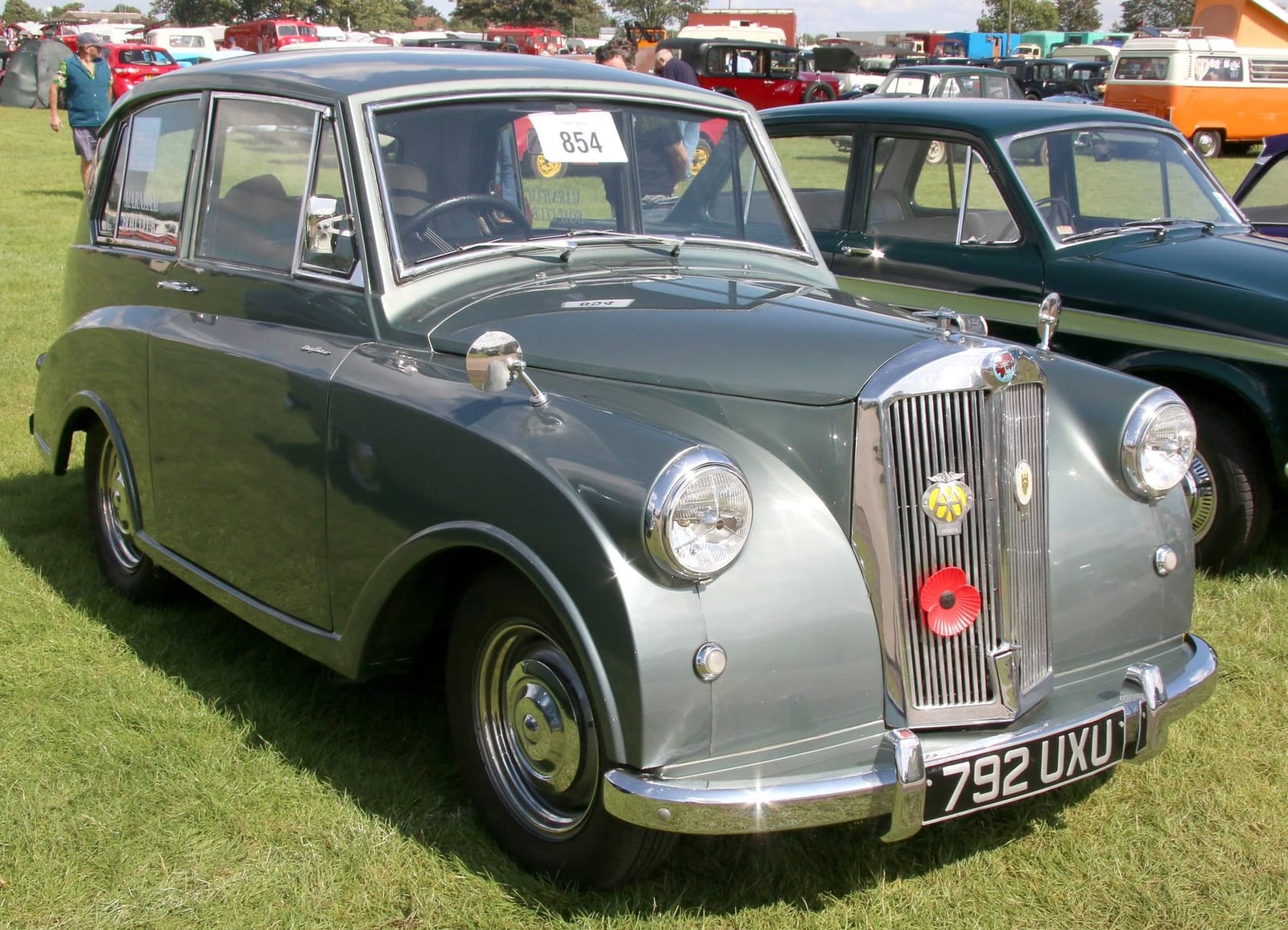 A grey-green Triumph Mayflower on grass at a steam rally, front three-quarter view, UK registration 792 UXU