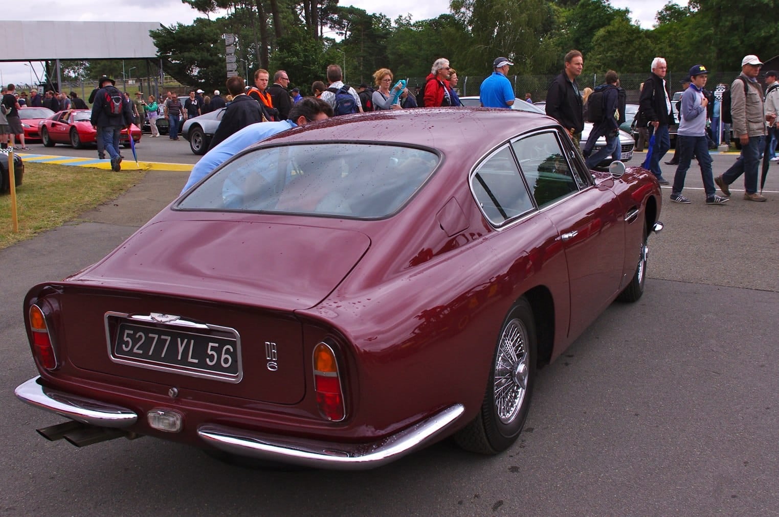 The rear view of a maroon Aston Martin DB6 showing the Kamm tail spoiler