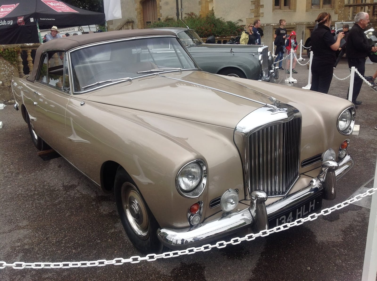 A gold 1960 Bentley S2 Continental drophead with UK registration 134 HLH at a concours