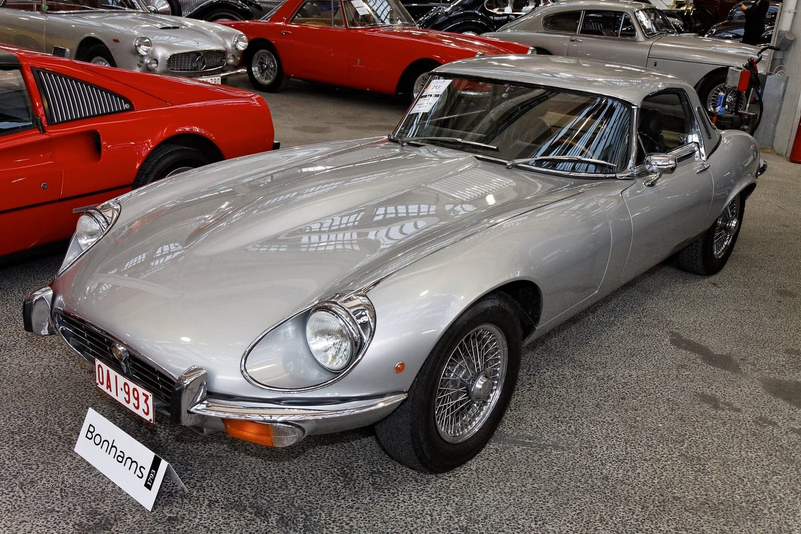 A silver Jaguar E-Type Series 3 V12 roadster fitted with the factory hardtop, at an auction preview