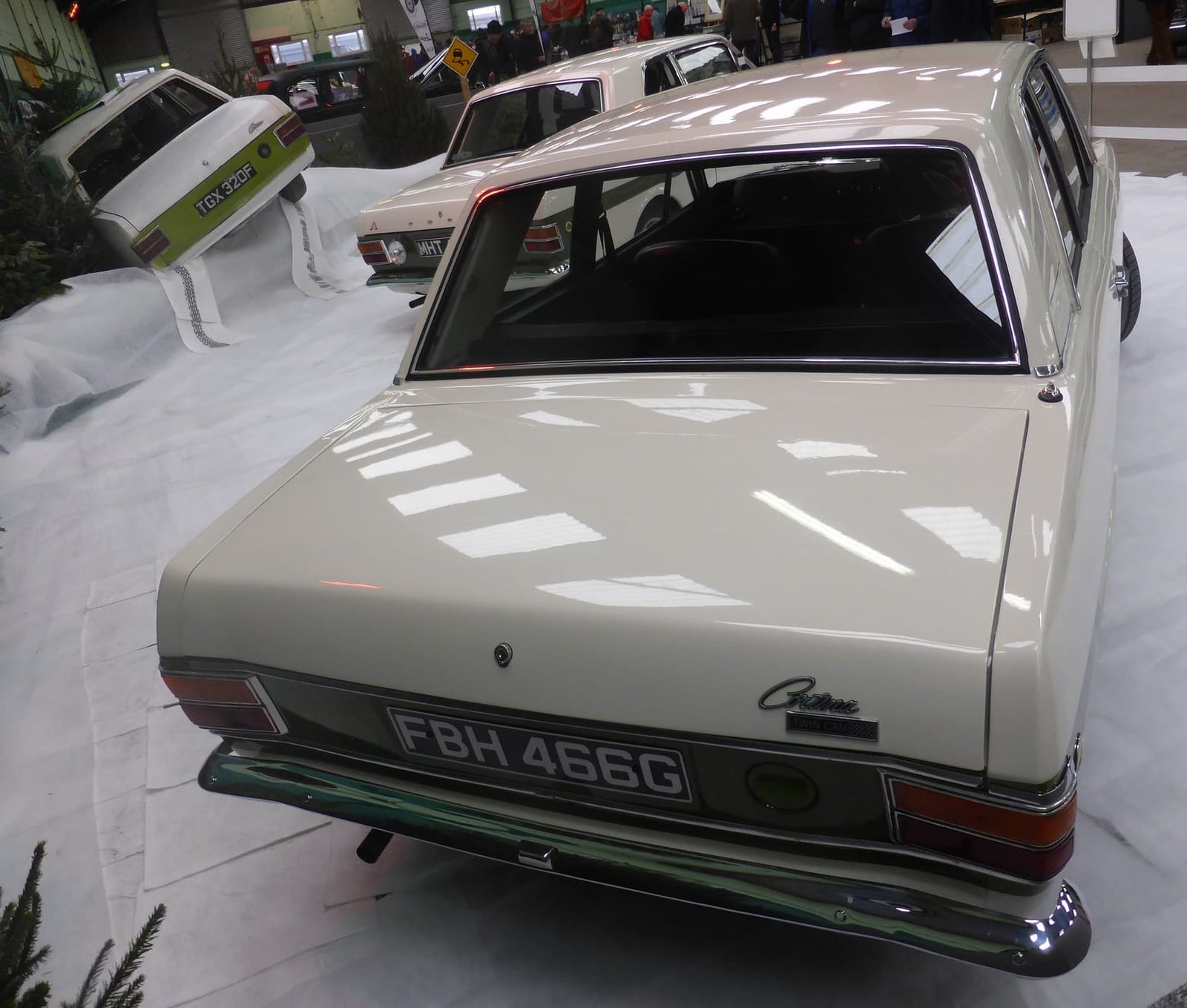 The rear of a white Lotus Cortina Mk2 showing the Cortina script, Lotus badge and green flash, UK registration FBH 466G