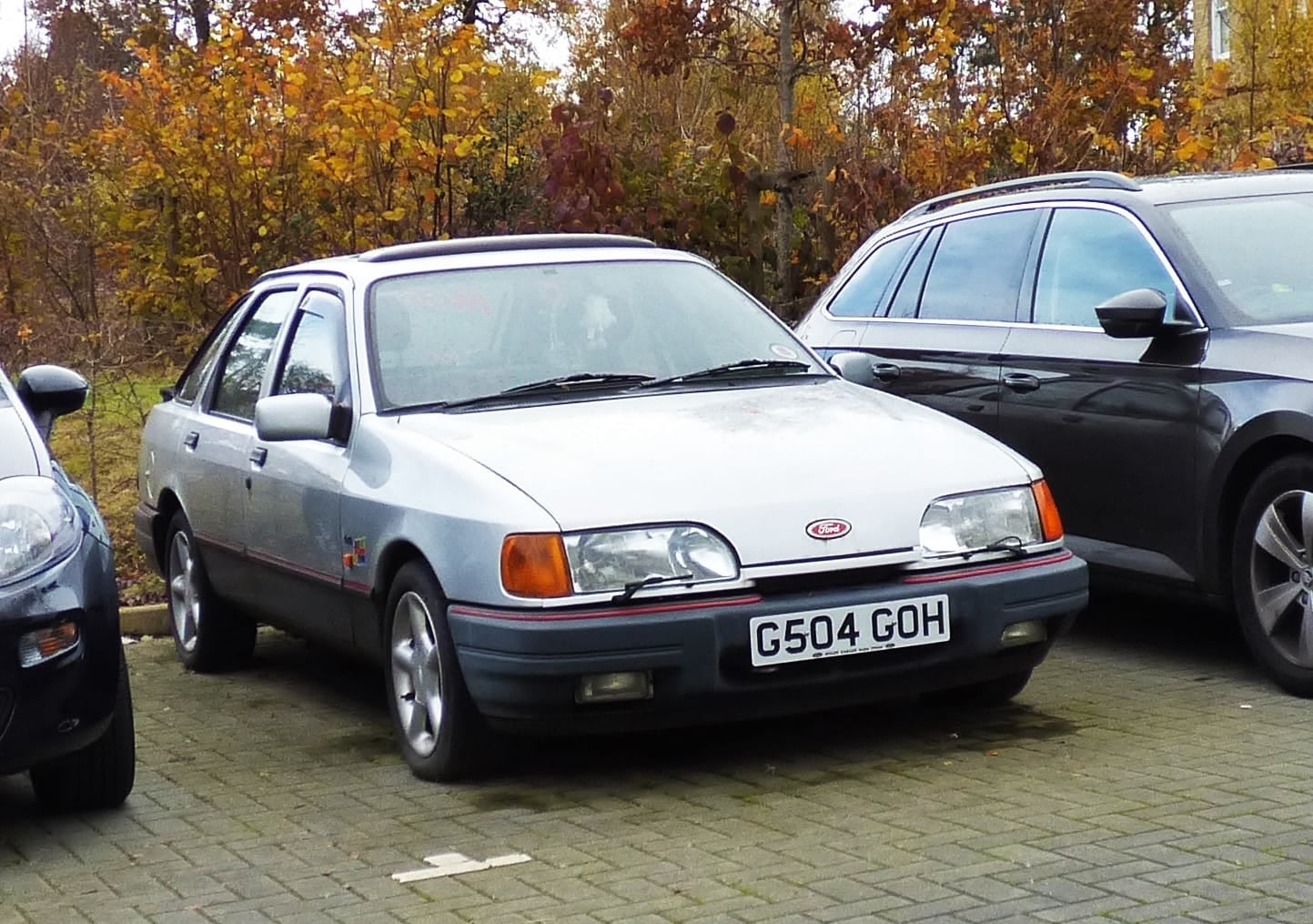 A silver Ford Sierra five-door hatchback, front three-quarter view in a car park