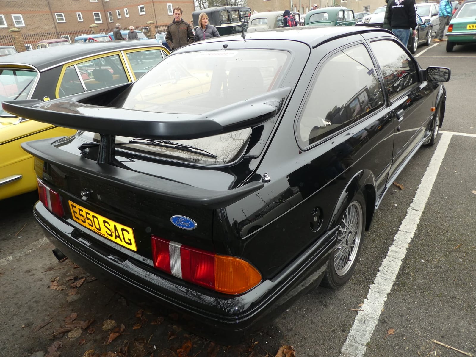 The tall bi-plane rear wing of a black Ford Sierra RS500 Cosworth