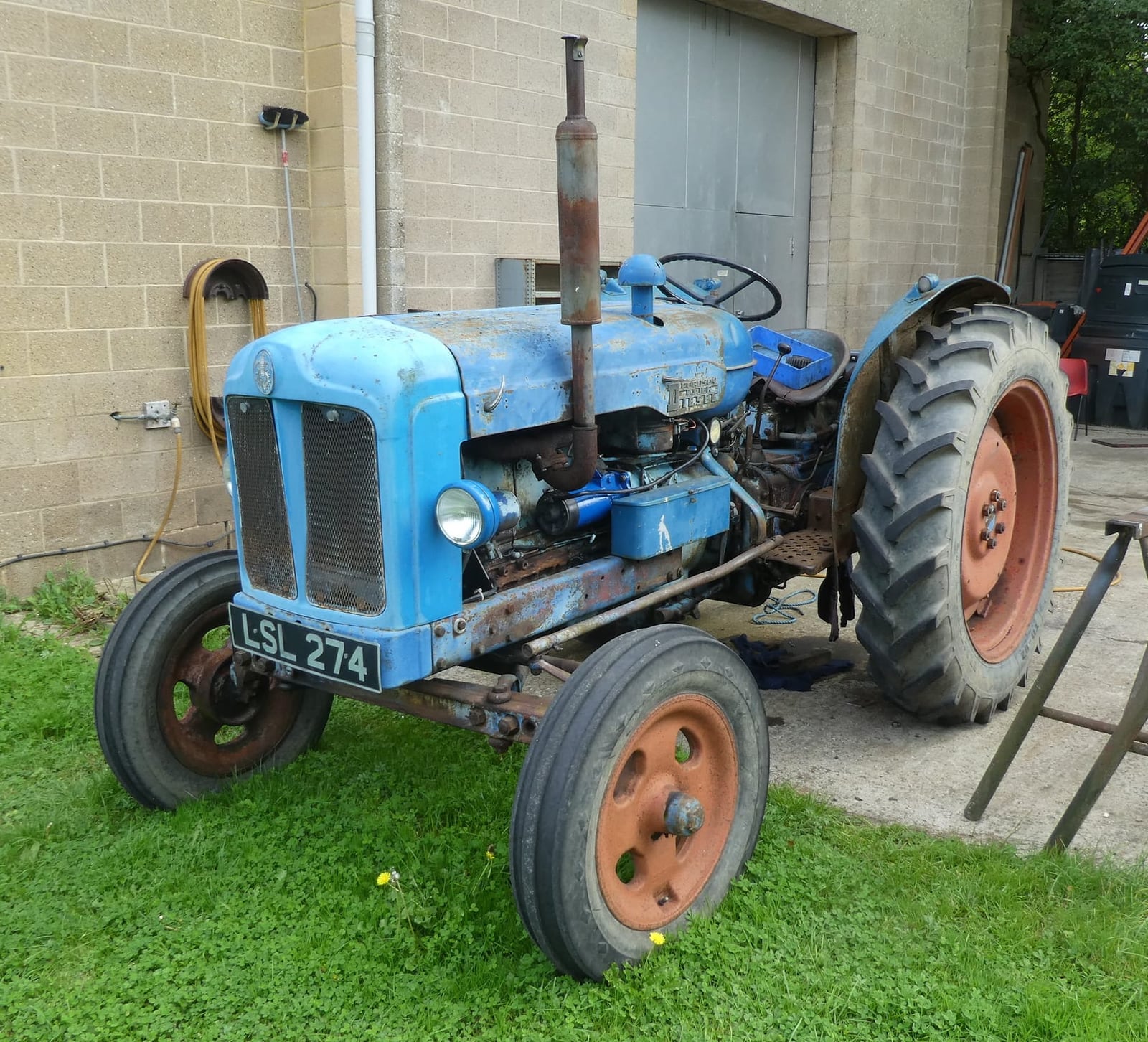 A work-worn blue 1952 Fordson Major Diesel on grass, UK registration LSL 274