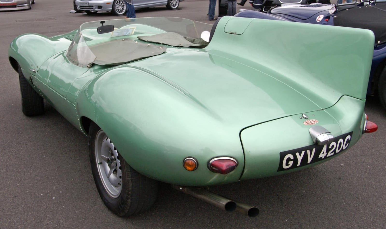 The rear of a pale green Jaguar D-Type showing the tail and exhausts, UK registration GYV 420C