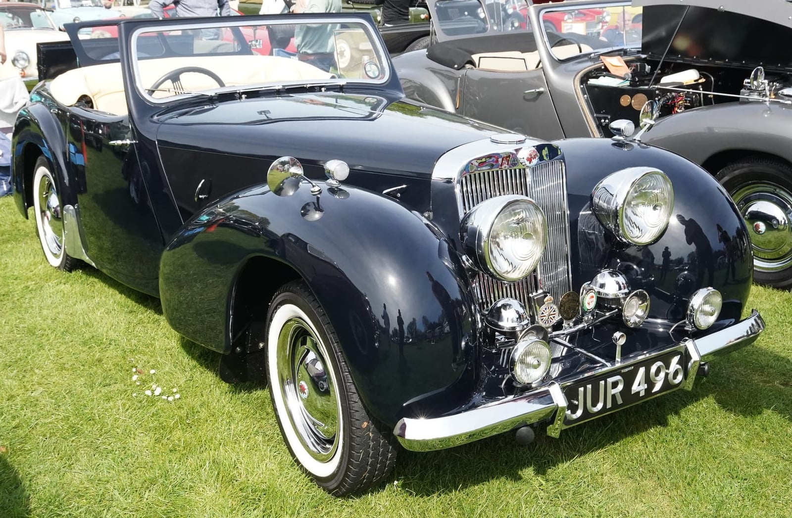 A black Triumph 1800 Roadster at a classic car show, front three-quarter view, UK registration JUR 496