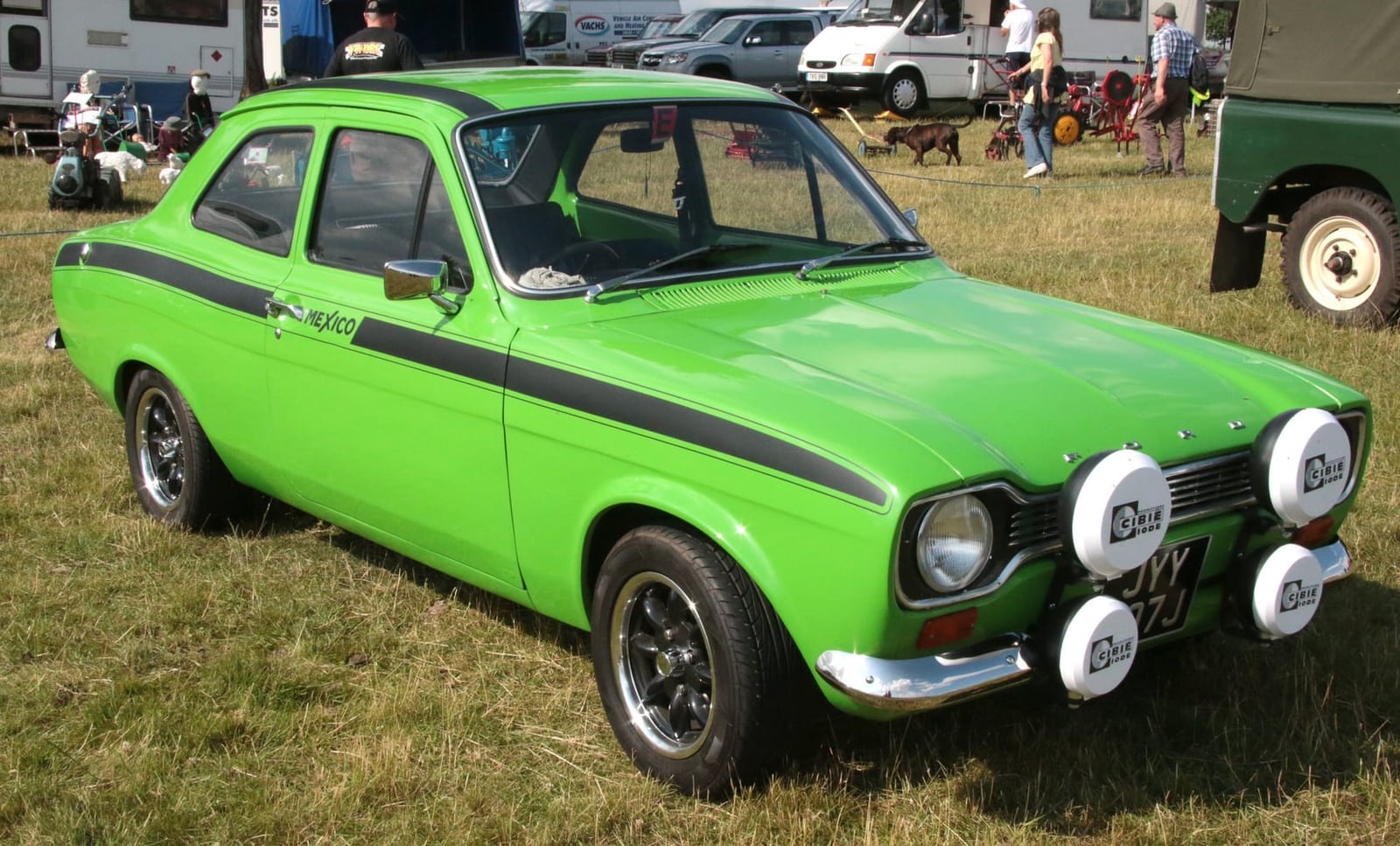 A green Mk1 Ford Escort Mexico with rally lamps, front three-quarter view
