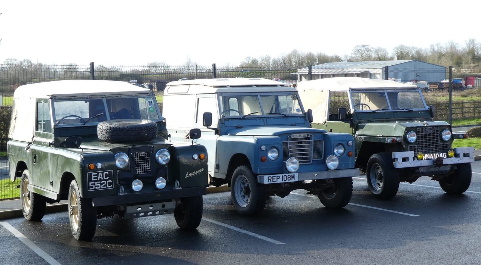 A line-up of military Land Rovers including Series and Lightweight models at a vehicle show