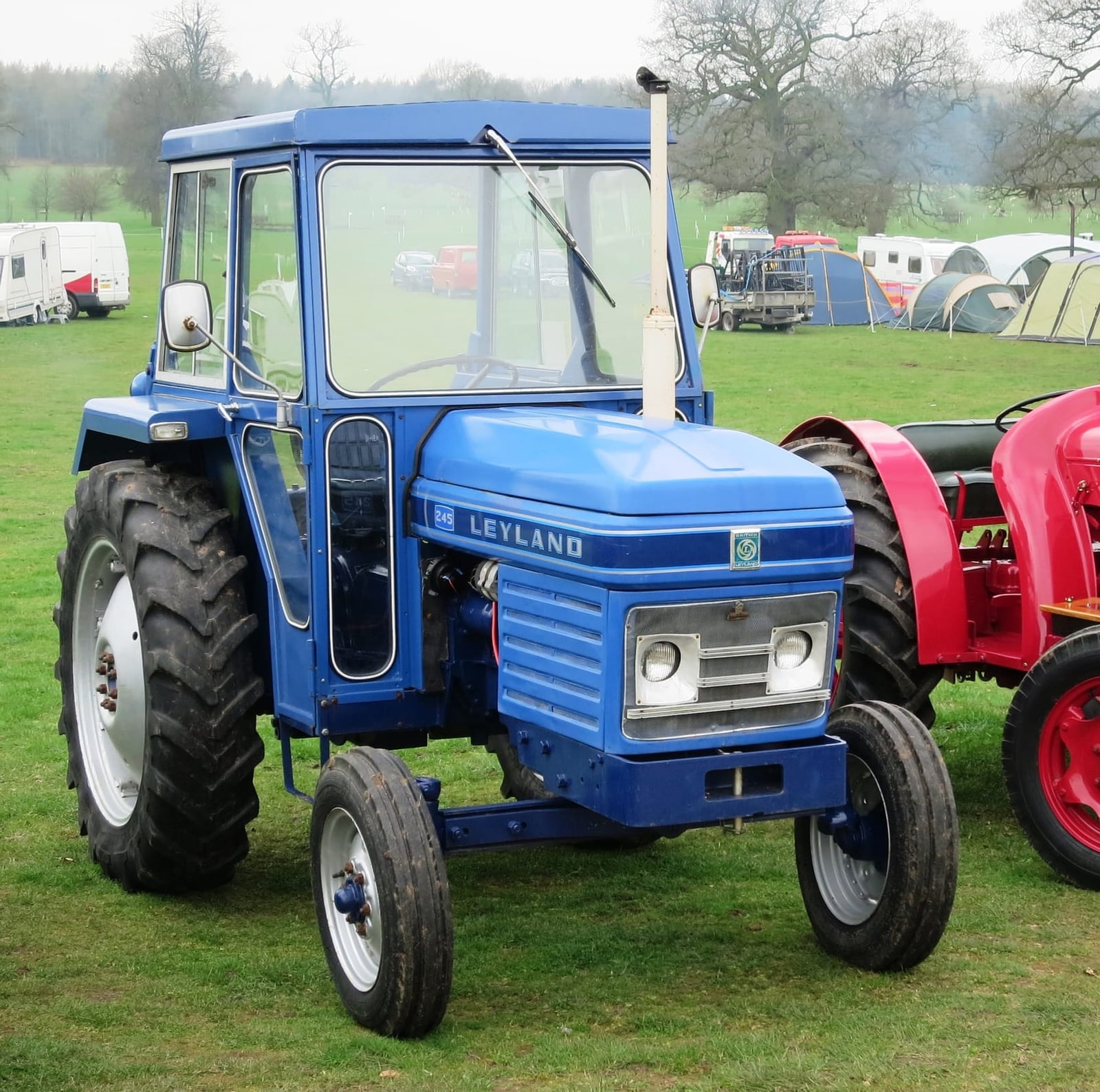 A two-tone blue Leyland 245 tractor at a show
