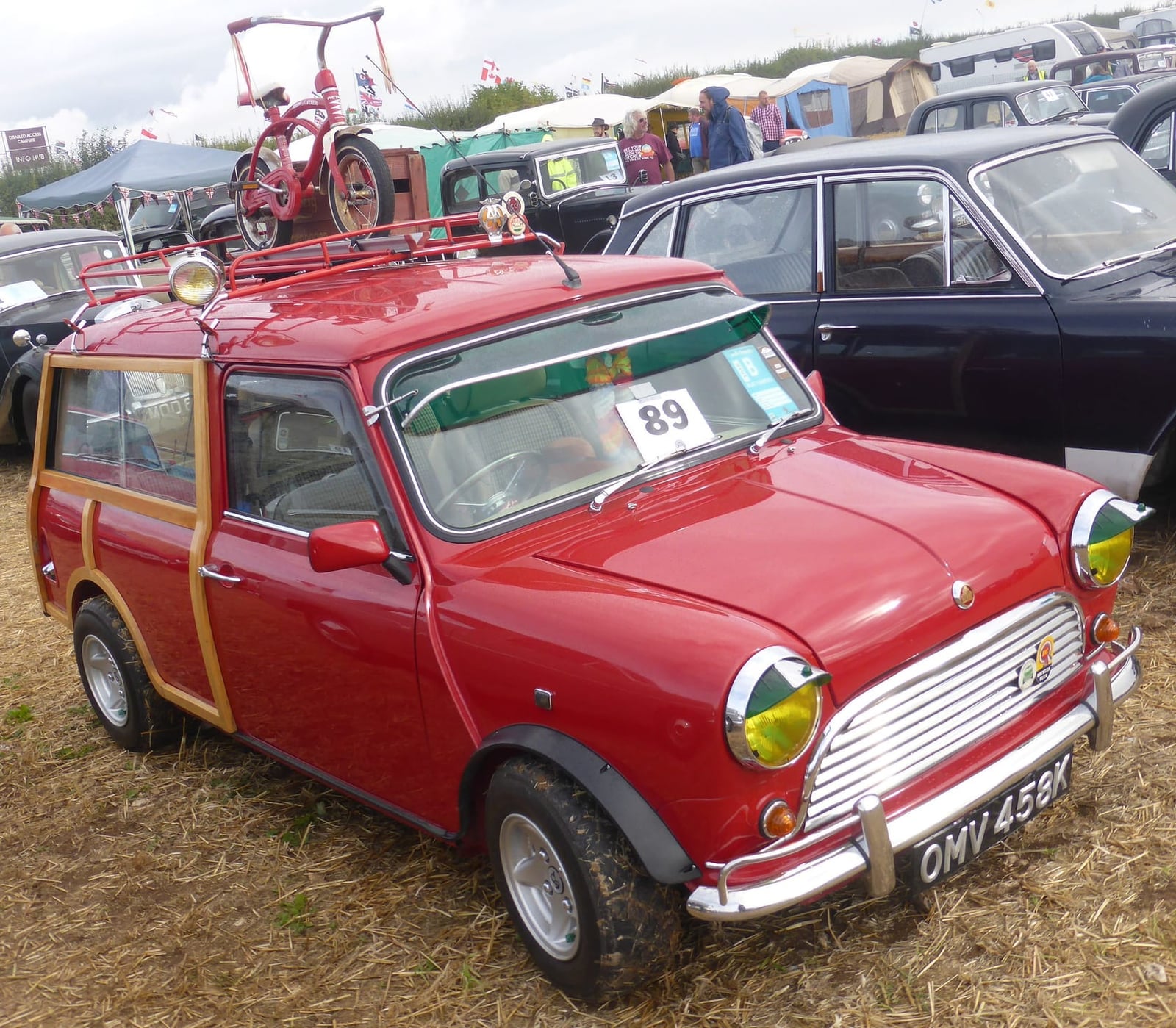 A red woody Mini Traveller with a roof rack, front three-quarter view