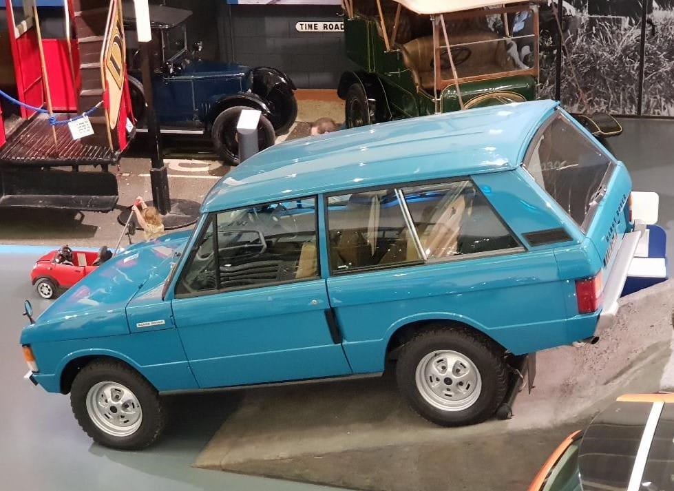 A blue 1969 pre-production Range Rover, the first of the line, displayed in a museum