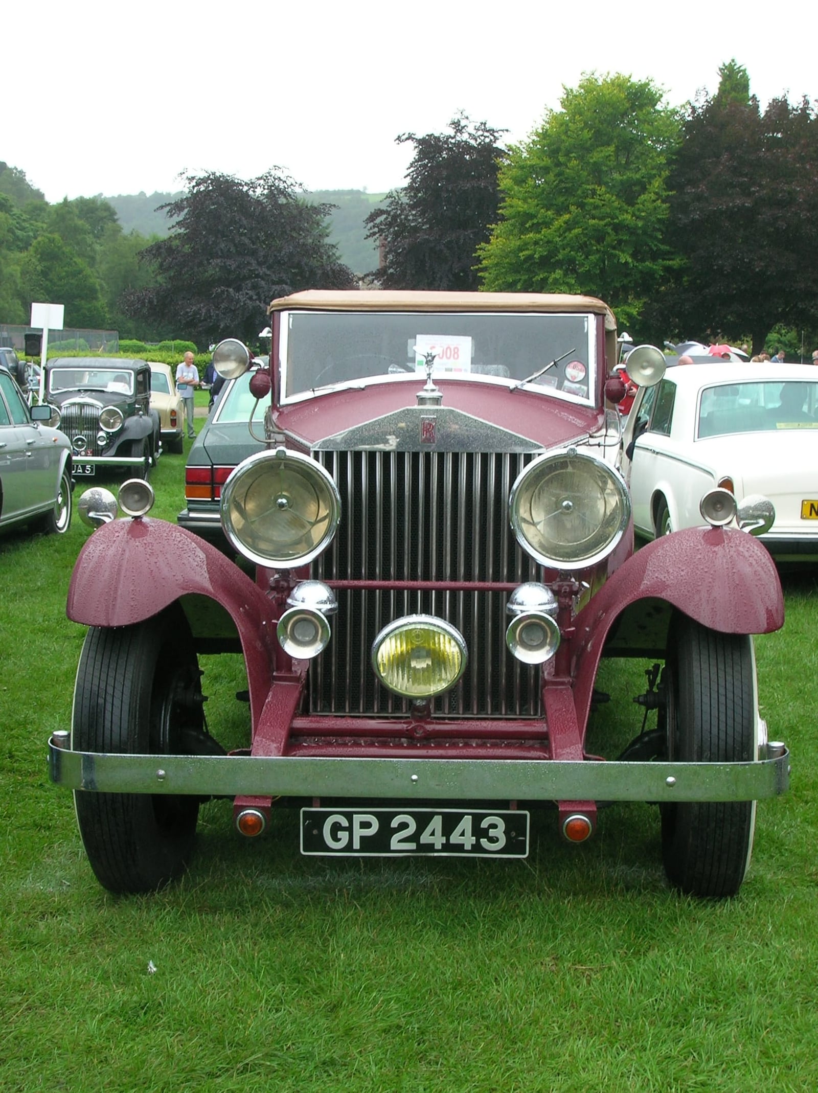 A maroon Rolls-Royce Phantom II with UK registration GP 2443 at an outdoor gathering