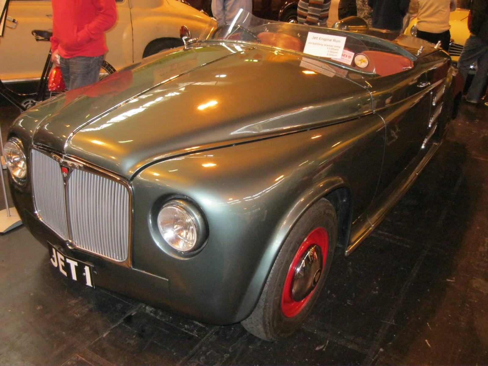 Rover JET1, a grey two-seater open car with the registration JET 1, seen nose-on at an indoor show