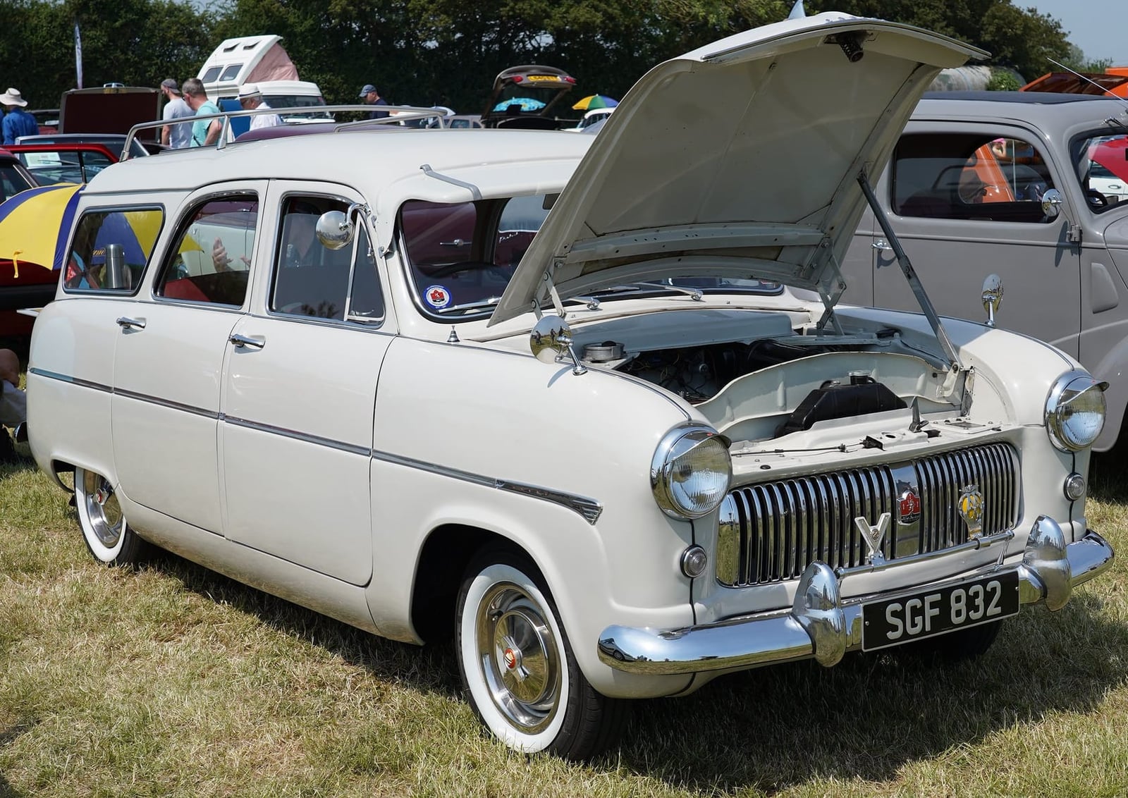 A cream Ford Consul Mk1 estate with the bonnet raised, at a show