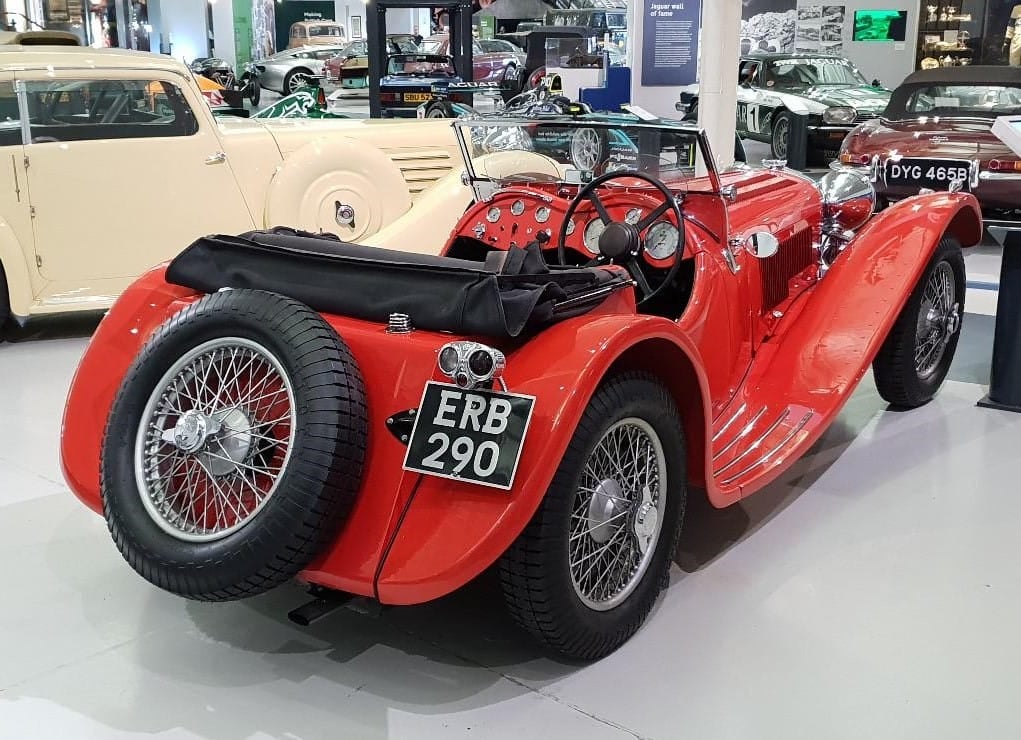 A red SS Jaguar 100 open sports car, rear three-quarter view, UK registration ERB 290