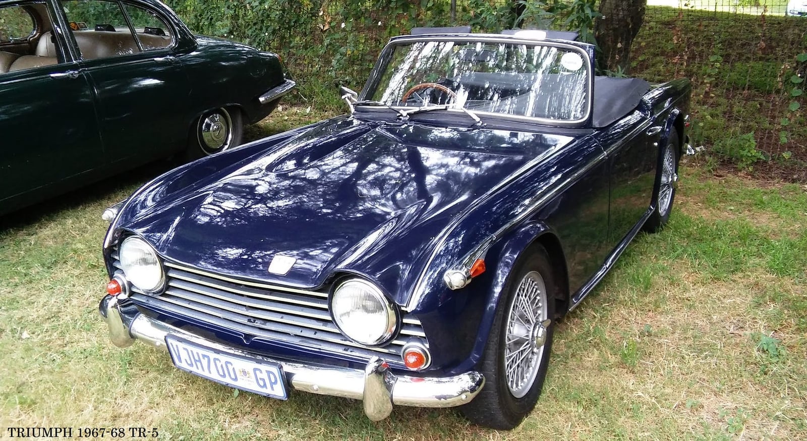 A dark blue Triumph TR5, front three-quarter view