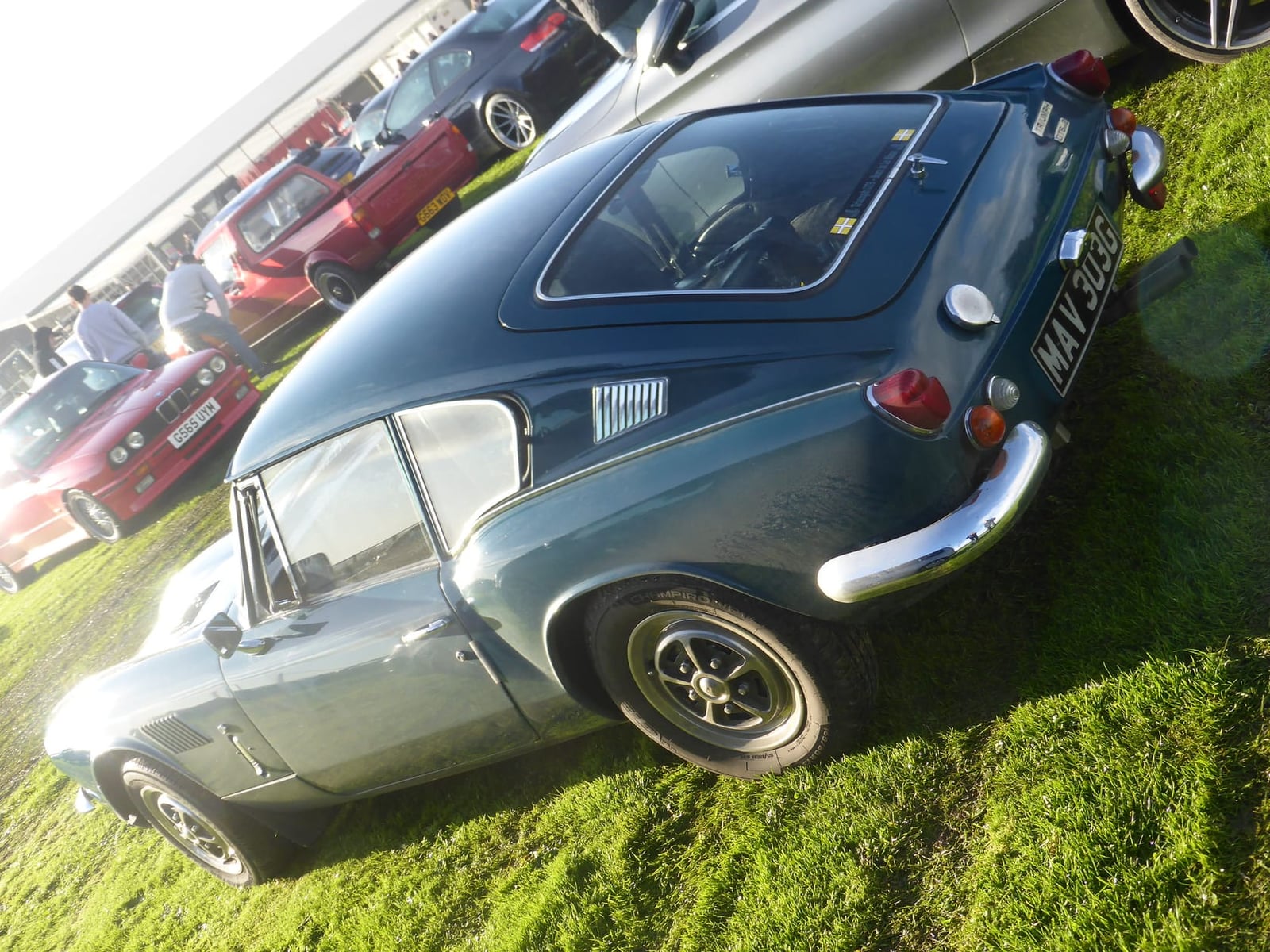 A dark green Triumph GT6 Mk2 fastback coupe, front three-quarter view