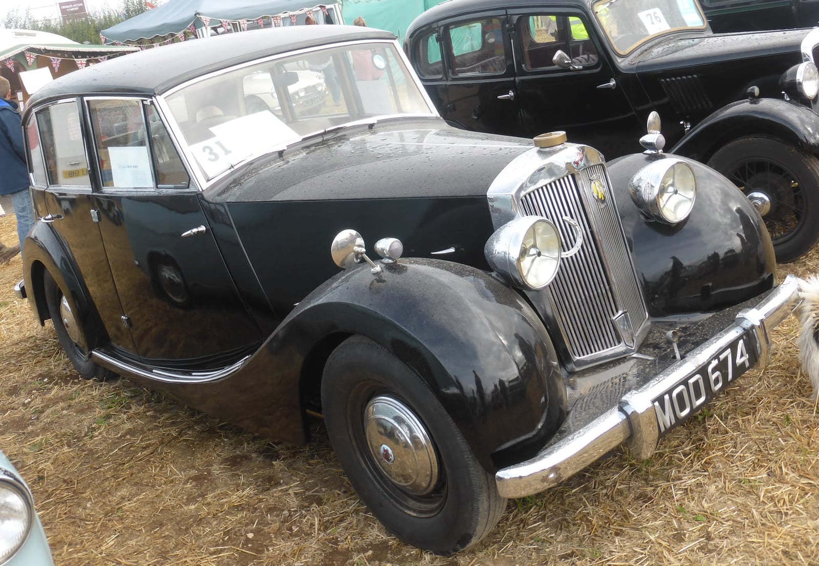 A grey and black 1951 Triumph Renown at a classic vehicle show, front three-quarter view, UK registration MOD 674