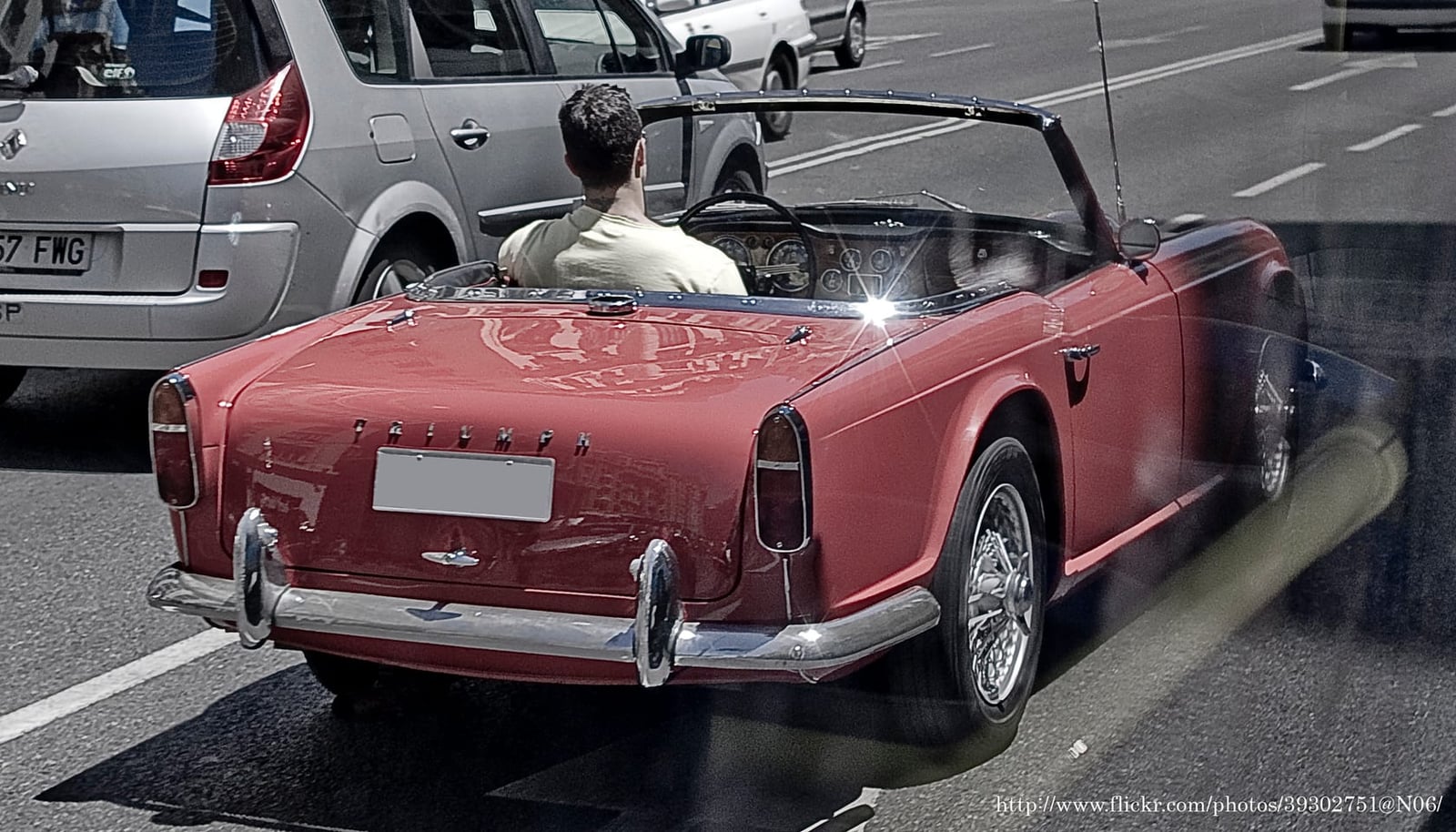 A red Triumph TR4, rear three-quarter view