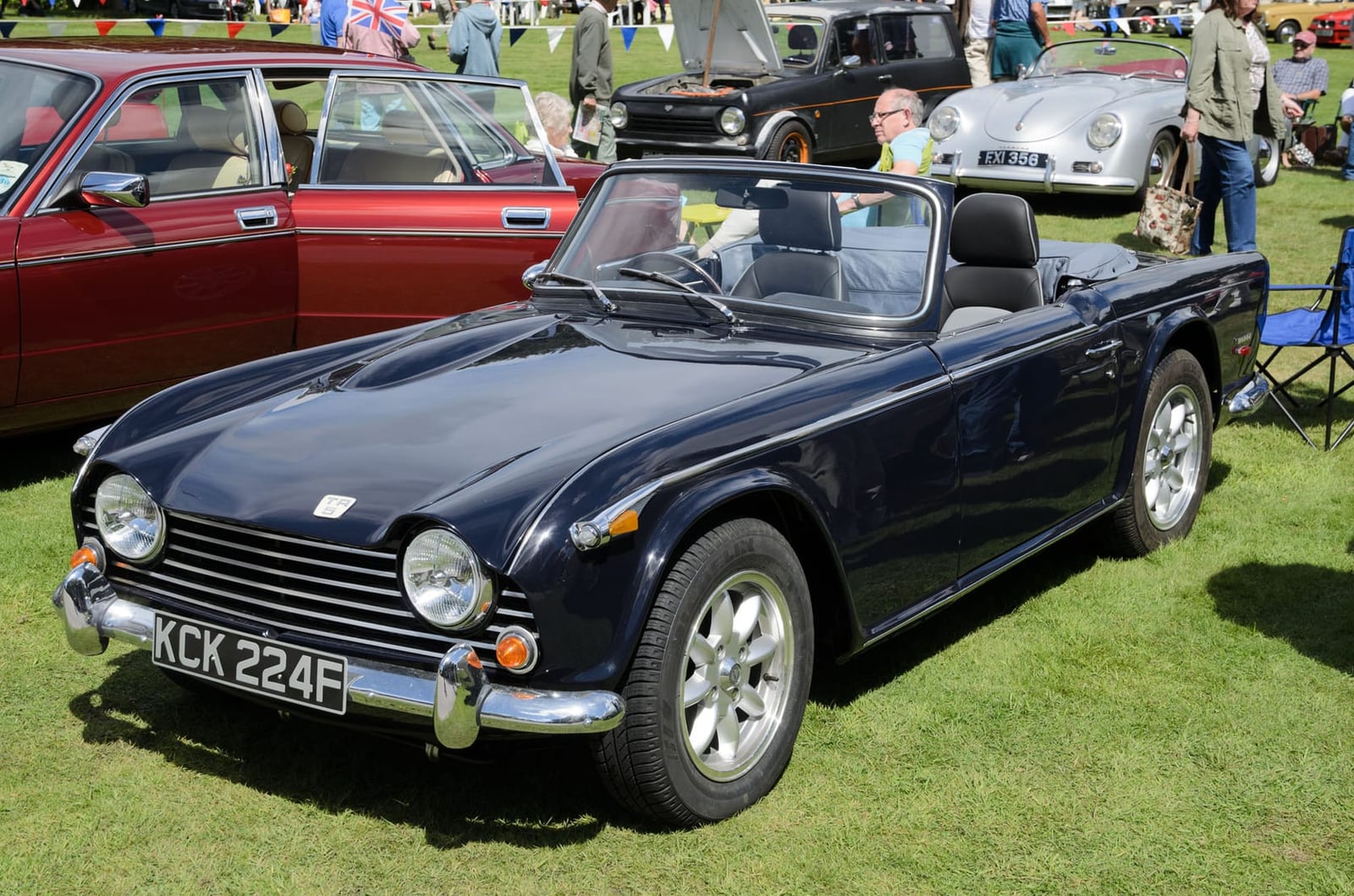 A dark Triumph TR5 roadster, front three-quarter view