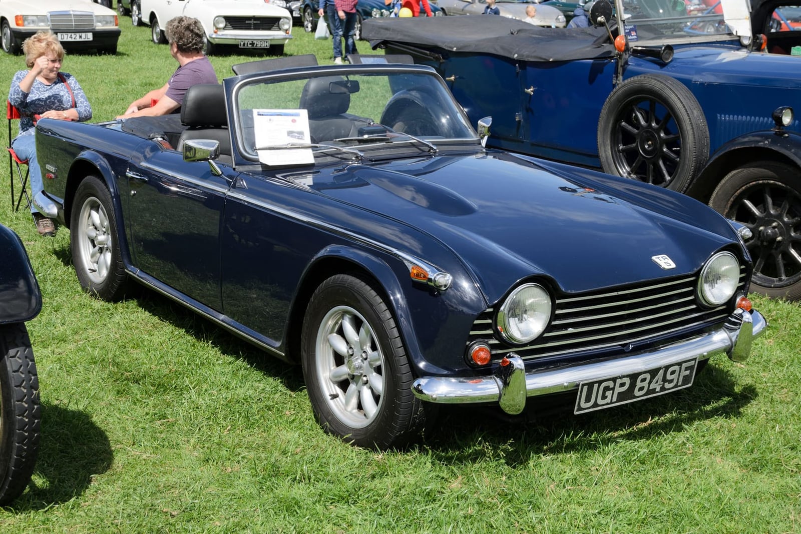 A red Triumph TR5, rear three-quarter view