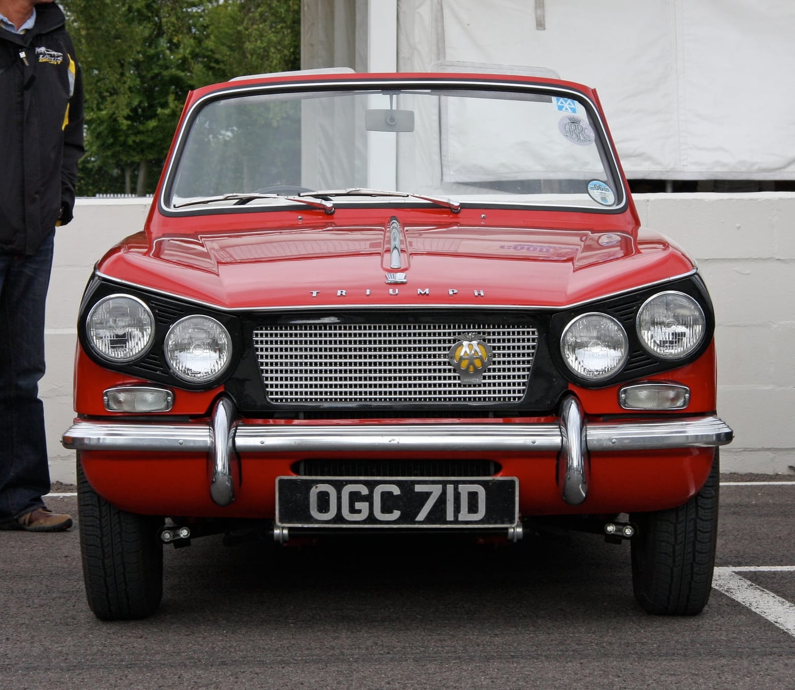 The front of a red Triumph Vitesse showing the slanted four-headlamp face, UK registration OGC 71D