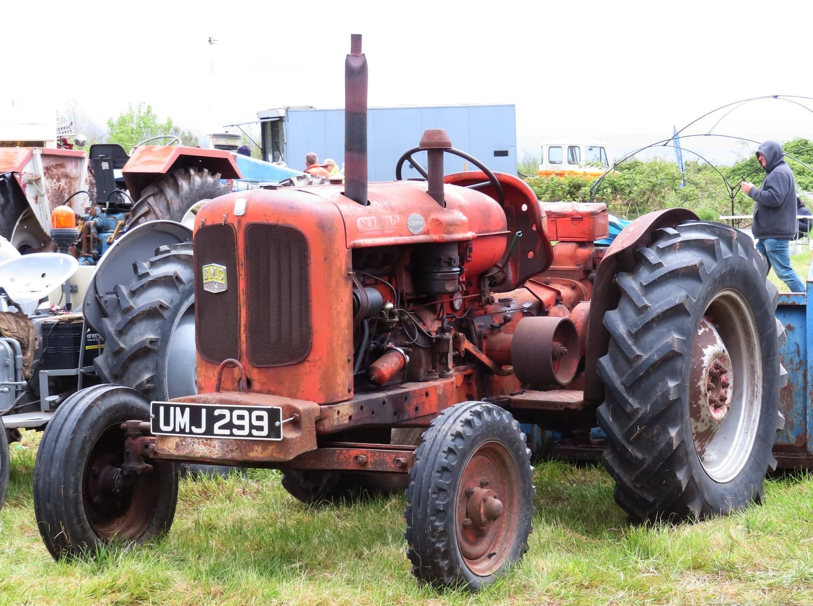 An orange Nuffield Universal, registration UMJ 299, at a show